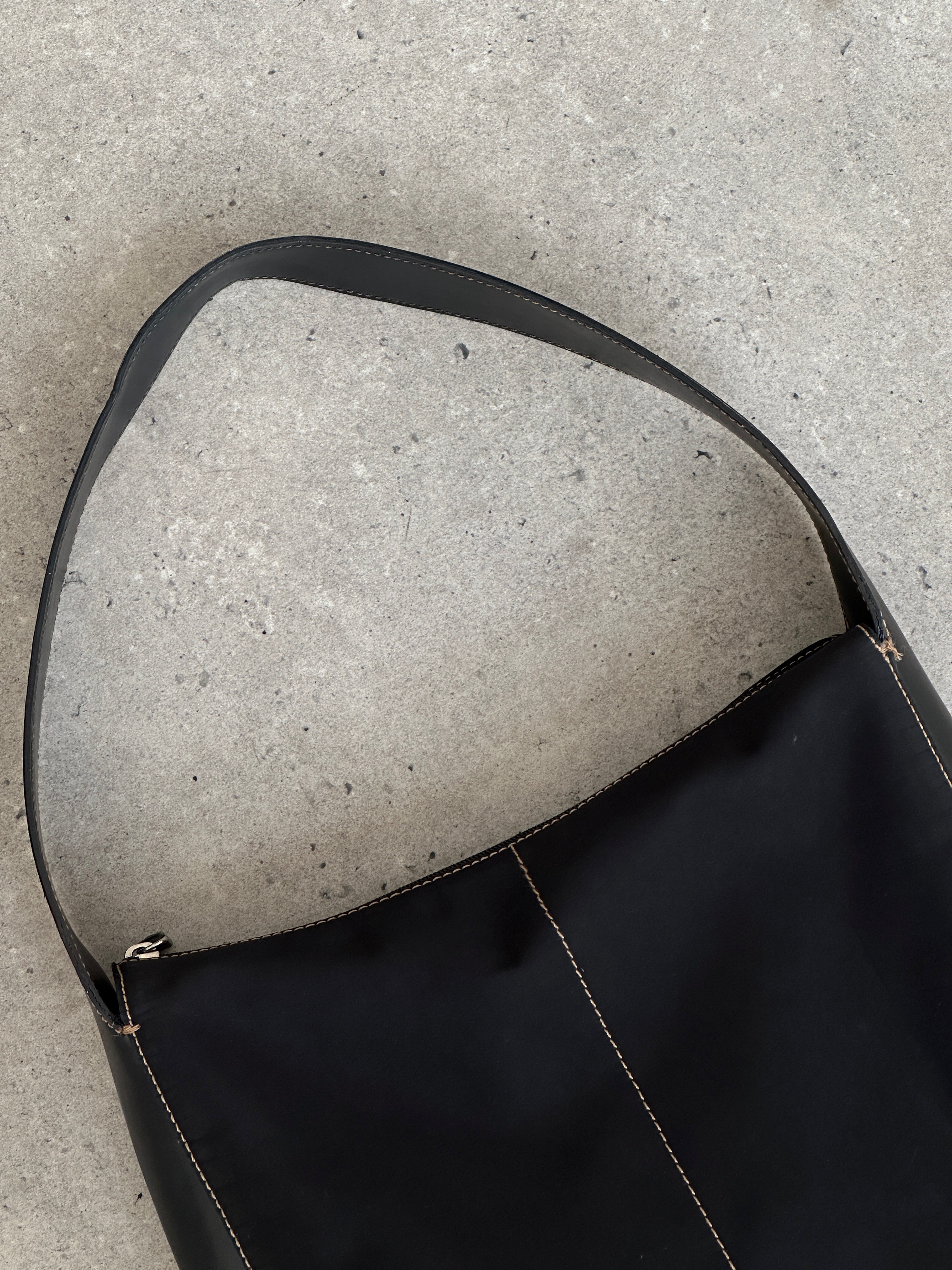 Donna Karan DKNY contrast stitch shoulder bag with sleek design, featuring a stylish bag in a classic shape and subtle detailing.