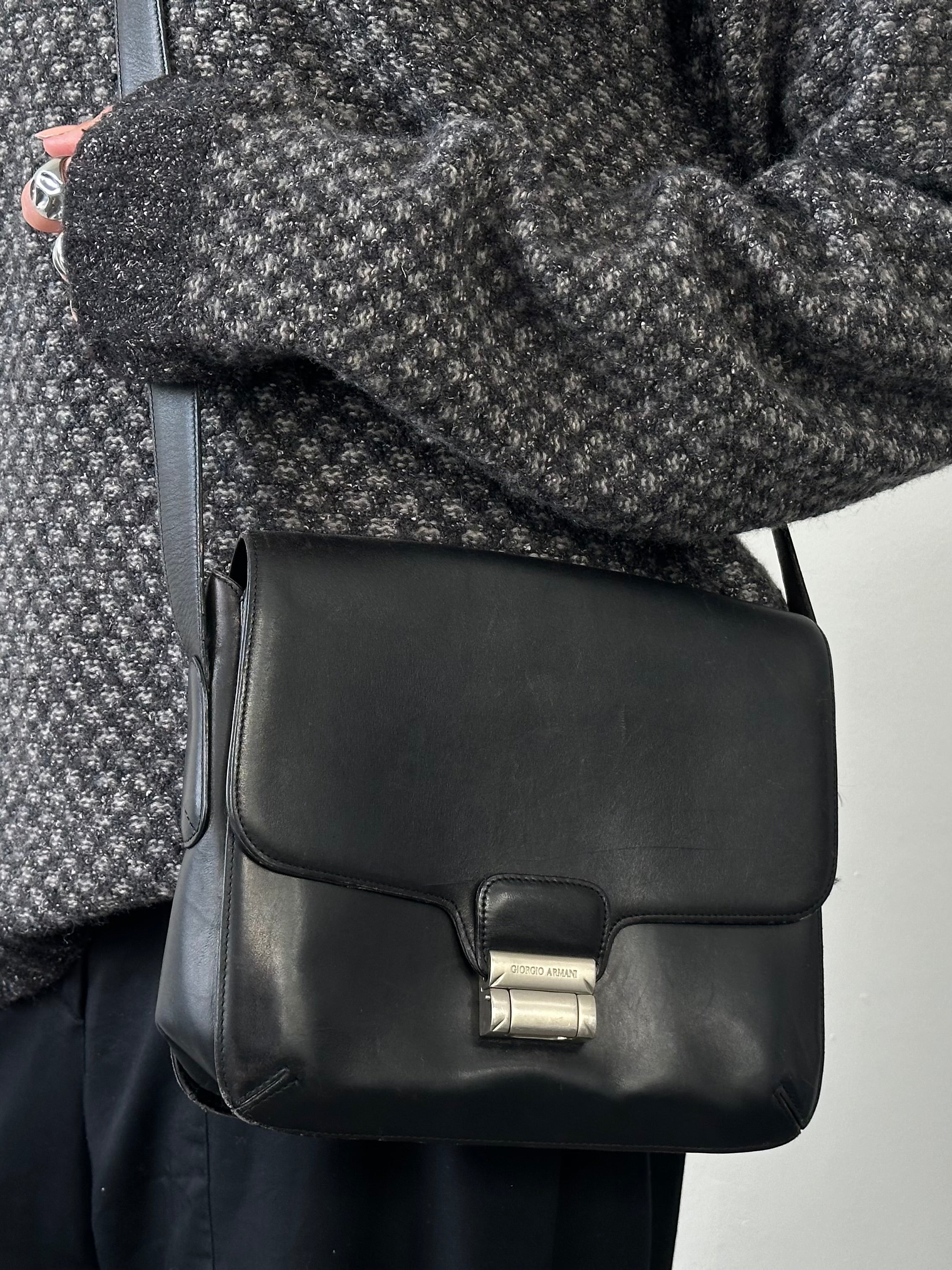Giorgio Armani Le Collezioni leather crossbody bag in black with adjustable strap and sleek design.