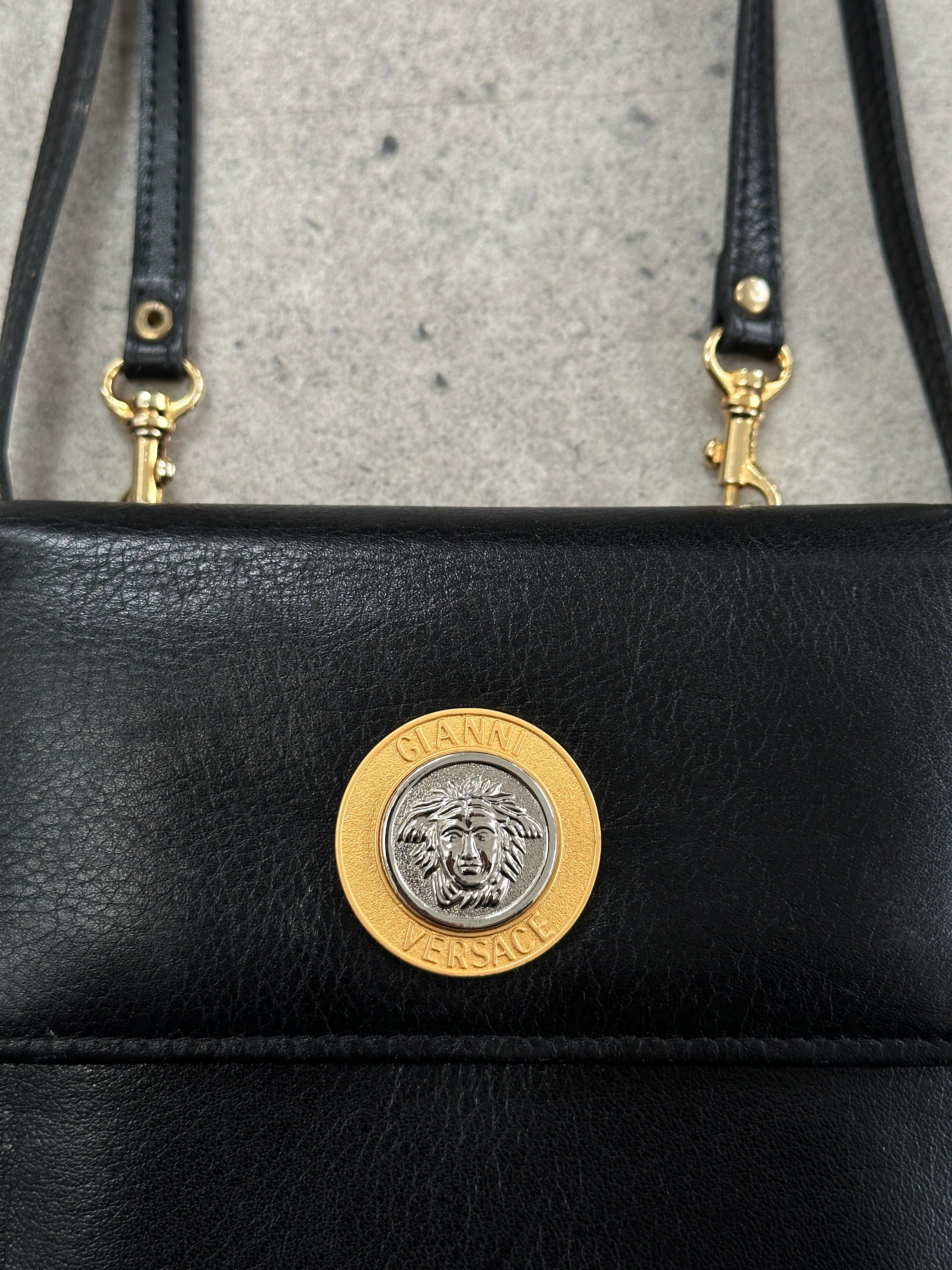 Gianni Versace 1990s Medusa leather crossbody bag with iconic Medusa logo and sleek design, crafted by Armani.