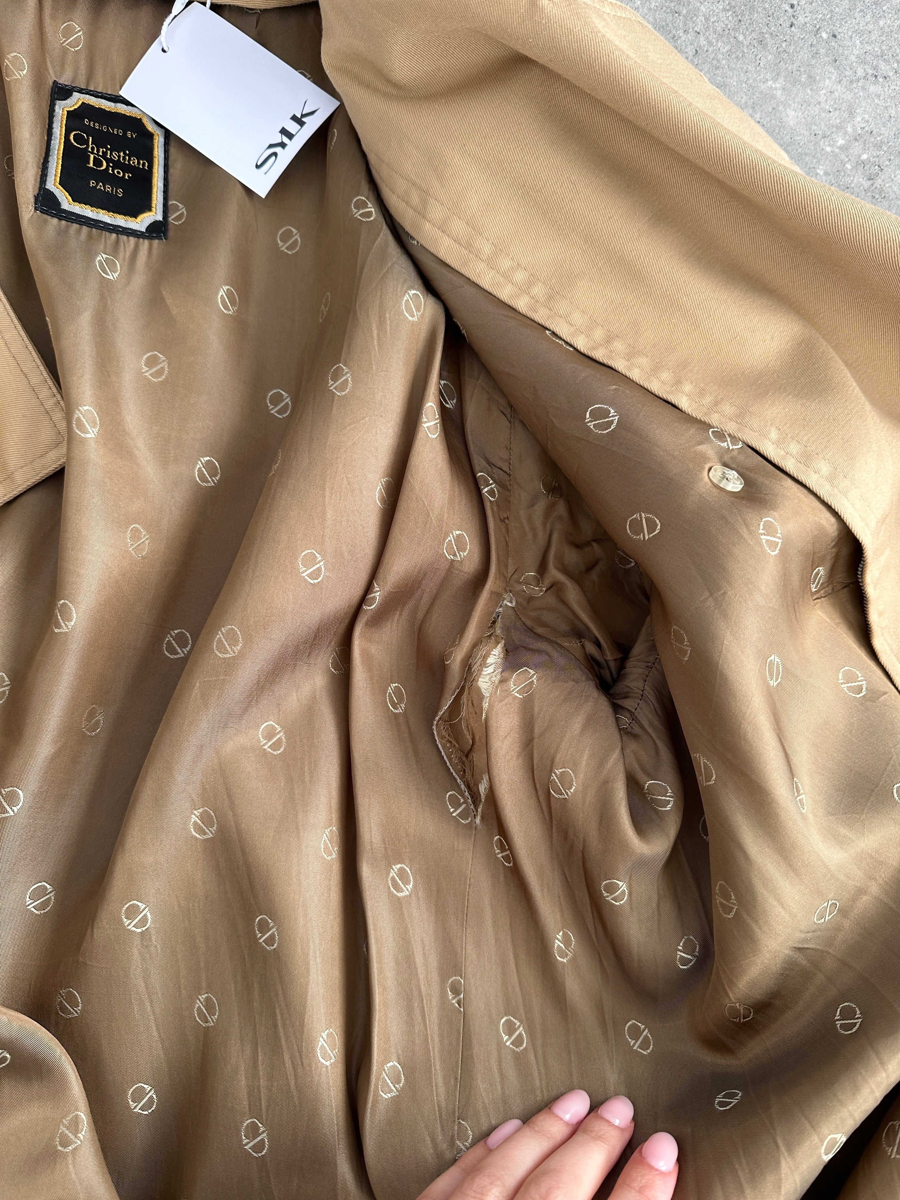 Christian Dior cotton double-breasted trench coat in size L/XL, shown on model with classic design and belt details.