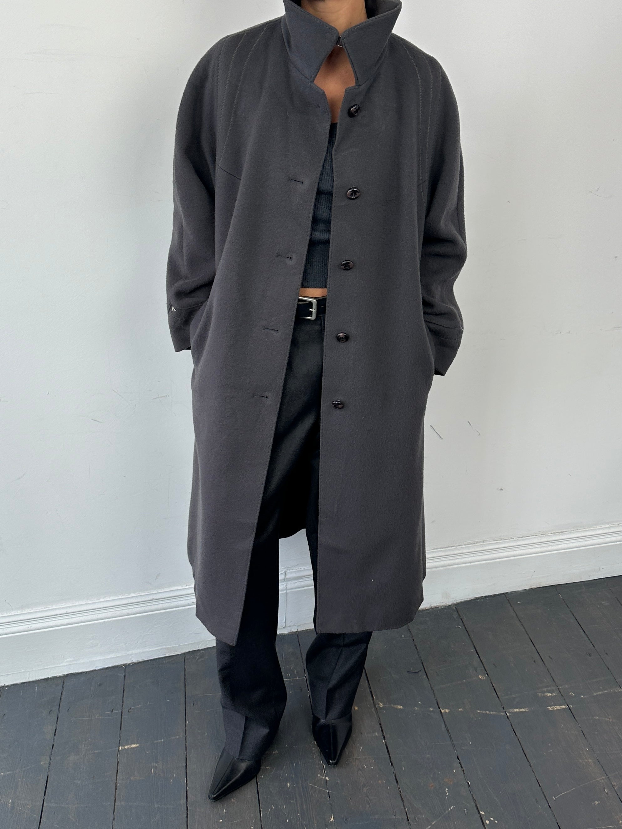 Vintage brand wool single-breasted coat in size M, showing classic tailored design with buttons and a lapel collar.