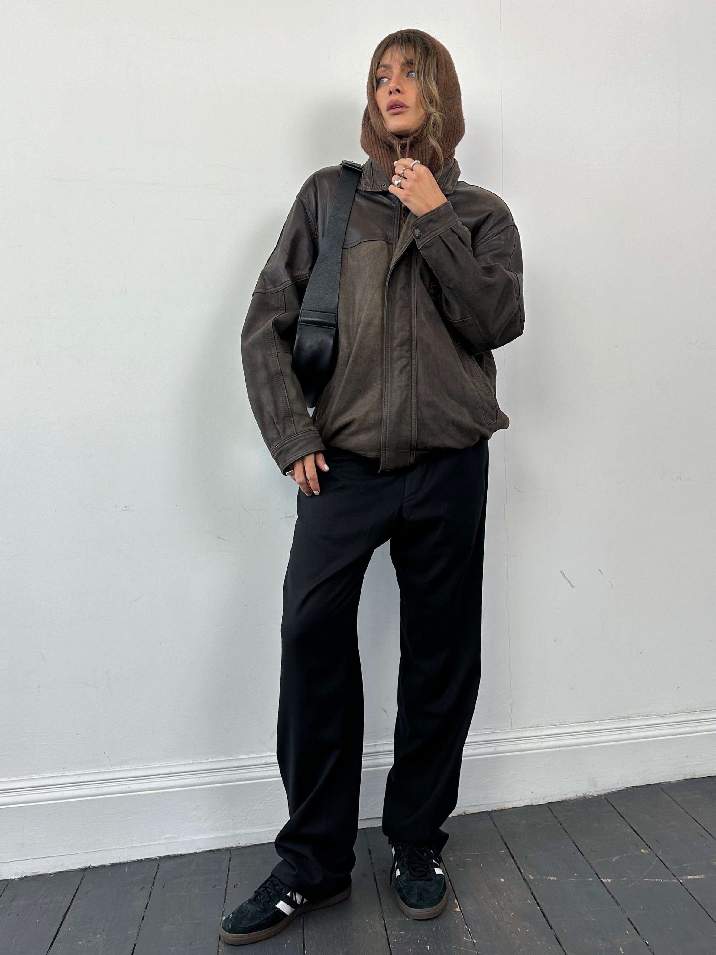 Vintage aged leather bomber jacket in size large, featuring classic collar and zip-front design, crafted from durable vintage leather.