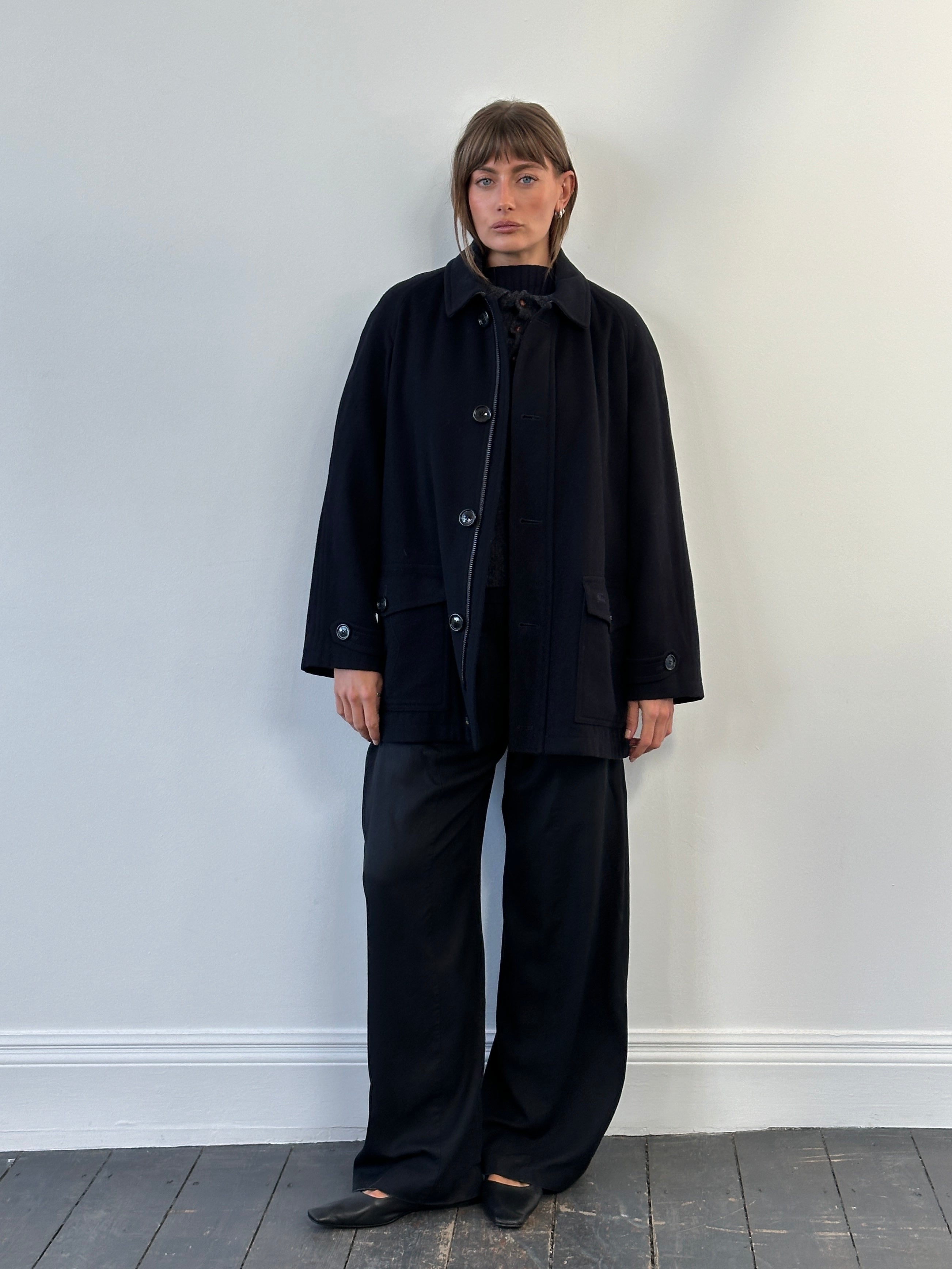 Burberry London 1990s wool single-breasted logo coat in size L/XL displayed hanging on a wooden hanger.