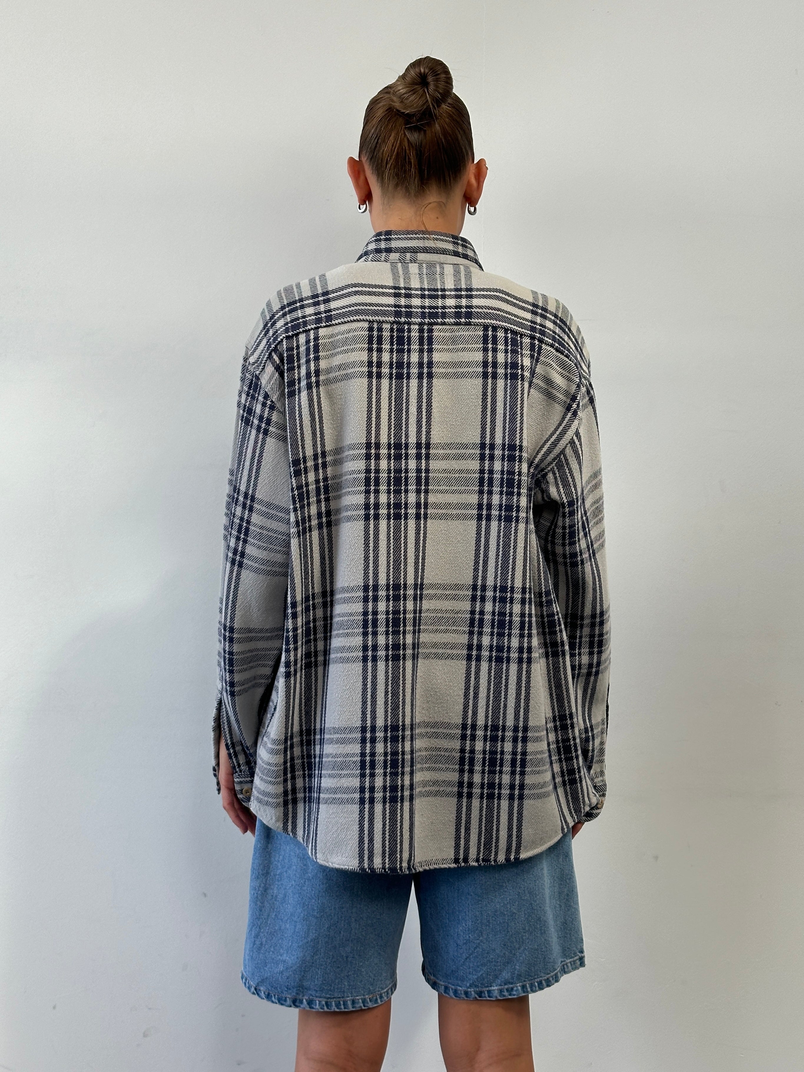 Armani Jeans check flannel pure cotton logo shirt in size L/XL displayed flat with classic plaid pattern and embroidered logo detail.