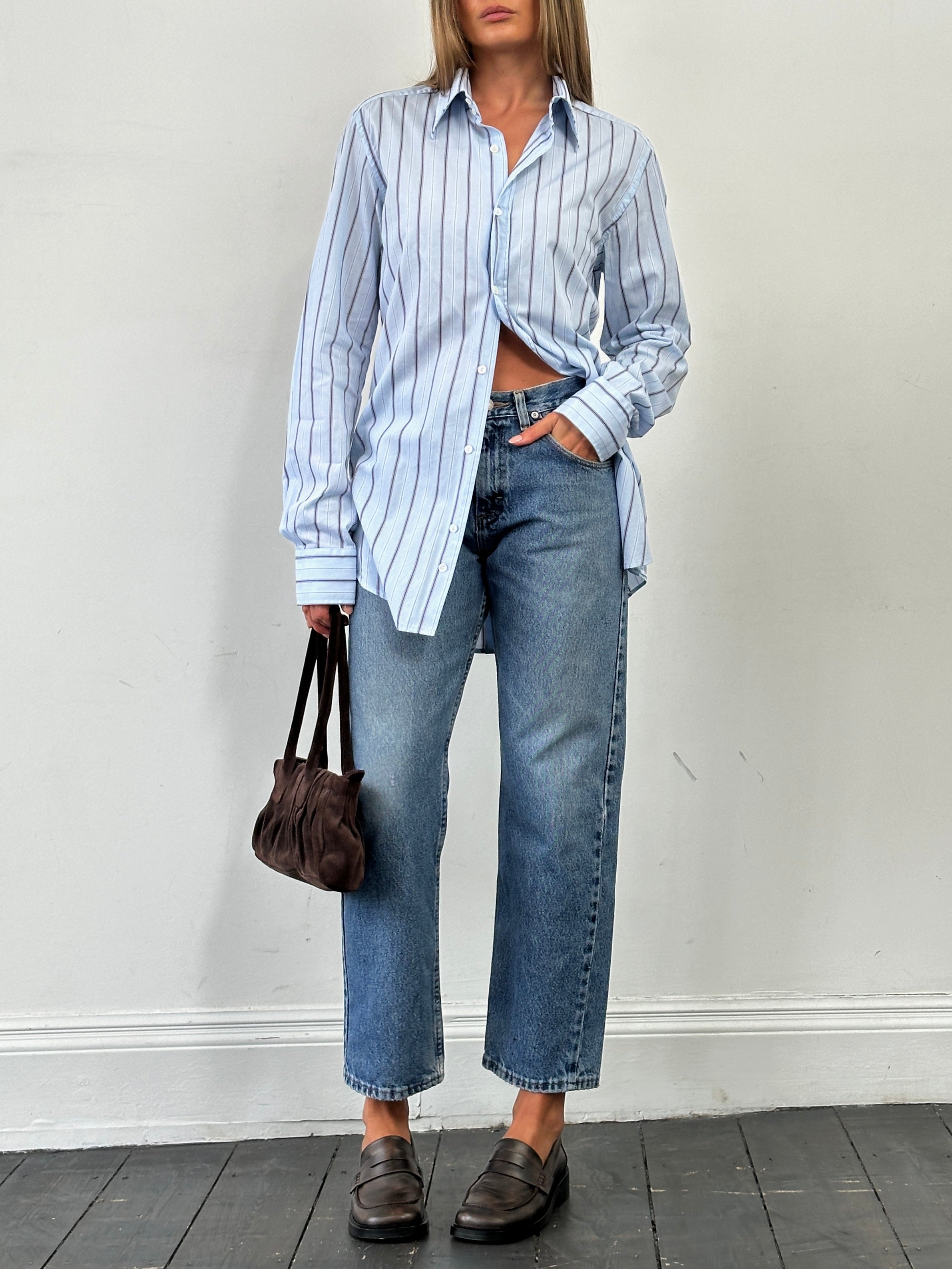 Wrangler mid wash straight leg high waisted denim jeans, size W28, shown on a model with front pockets and belt loops.