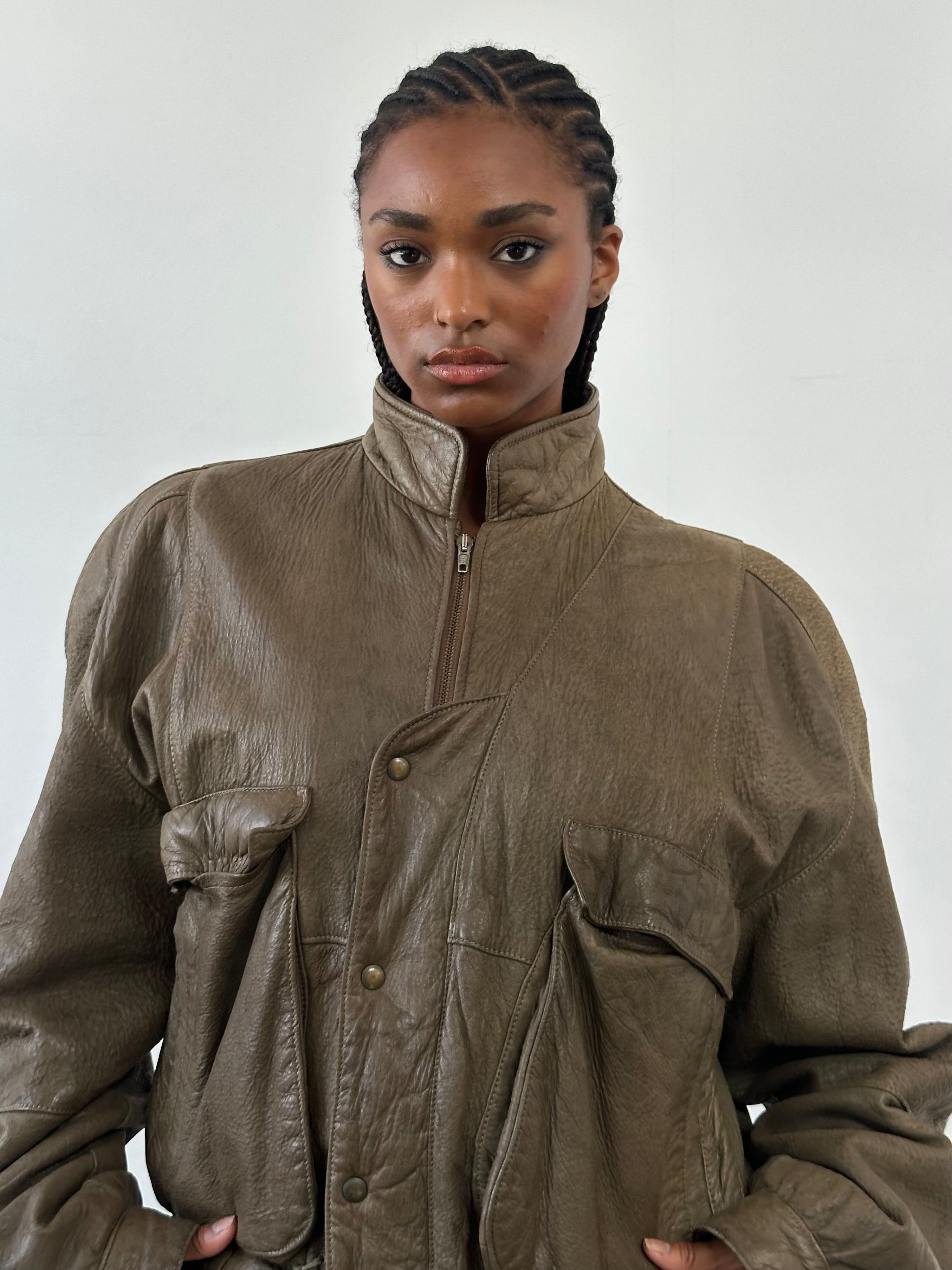 Vintage 1980s leather moto jacket in size large, featuring classic design and rugged leather texture.