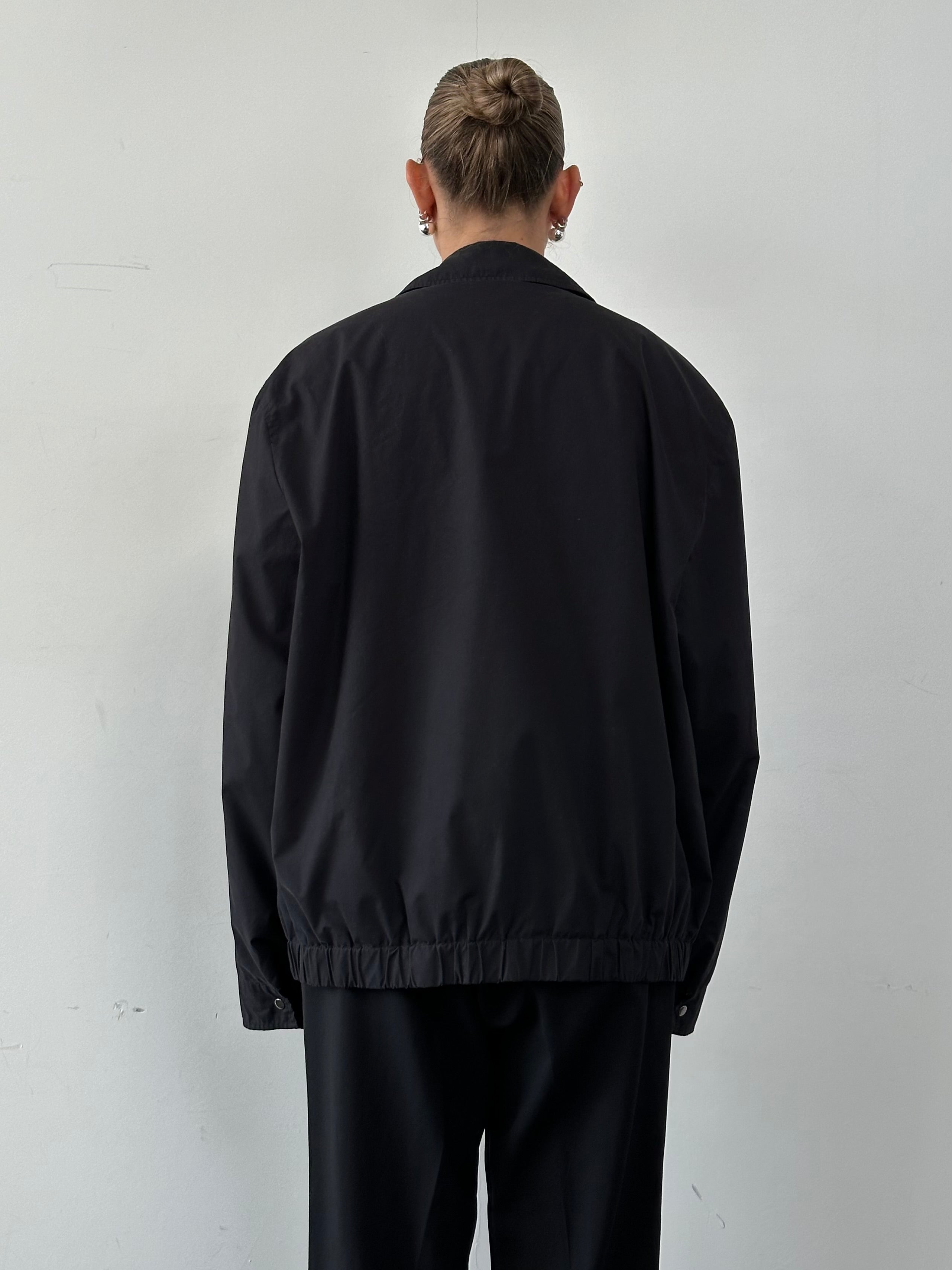 Yves Saint Laurent Pour Homme logo bomber jacket in XXL, black with signature branding, displayed on a hanger.