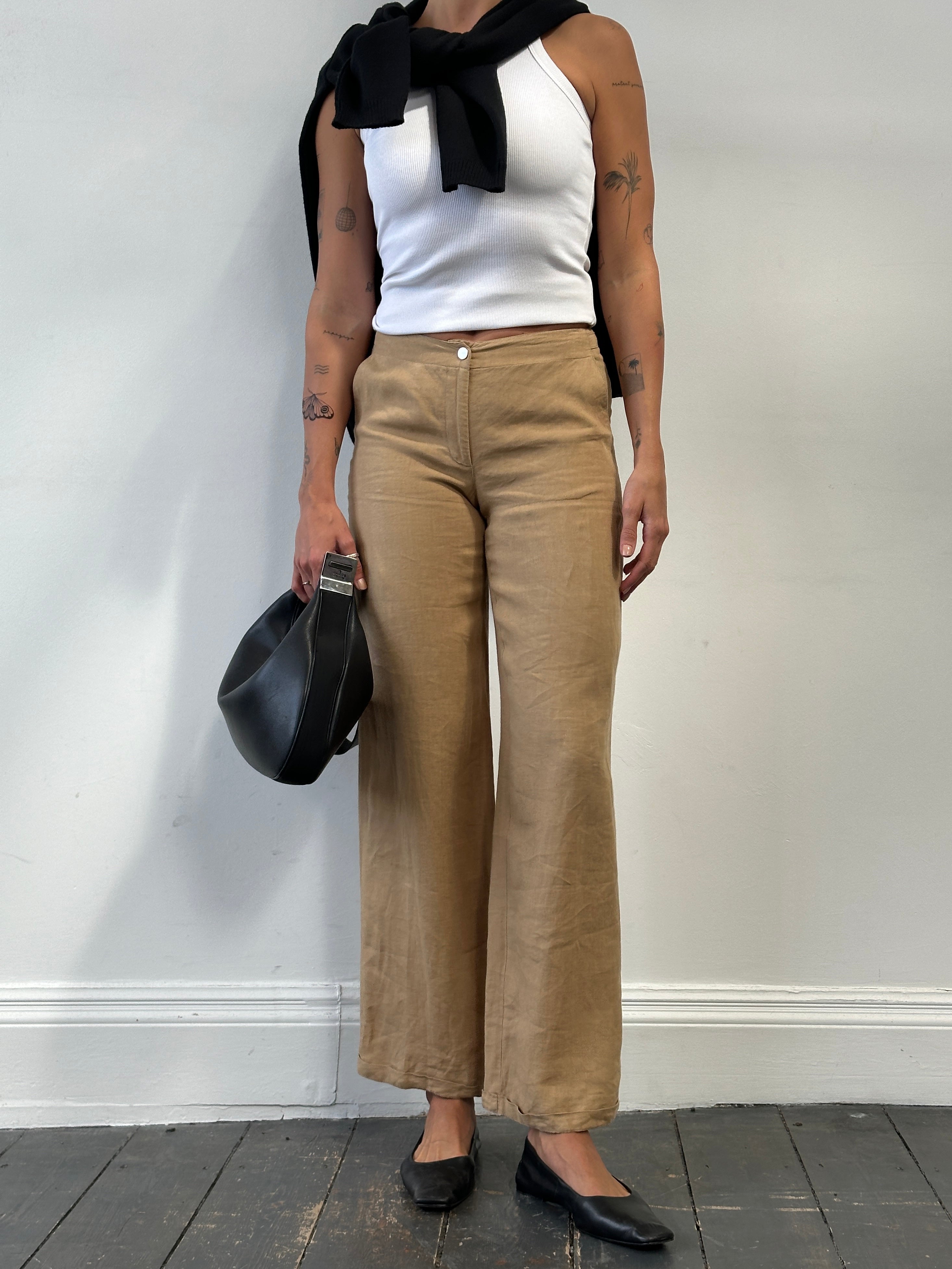 Vintage pure linen low waist wide-leg trousers W26 displayed on a hanger with natural folds and light fabric texture.