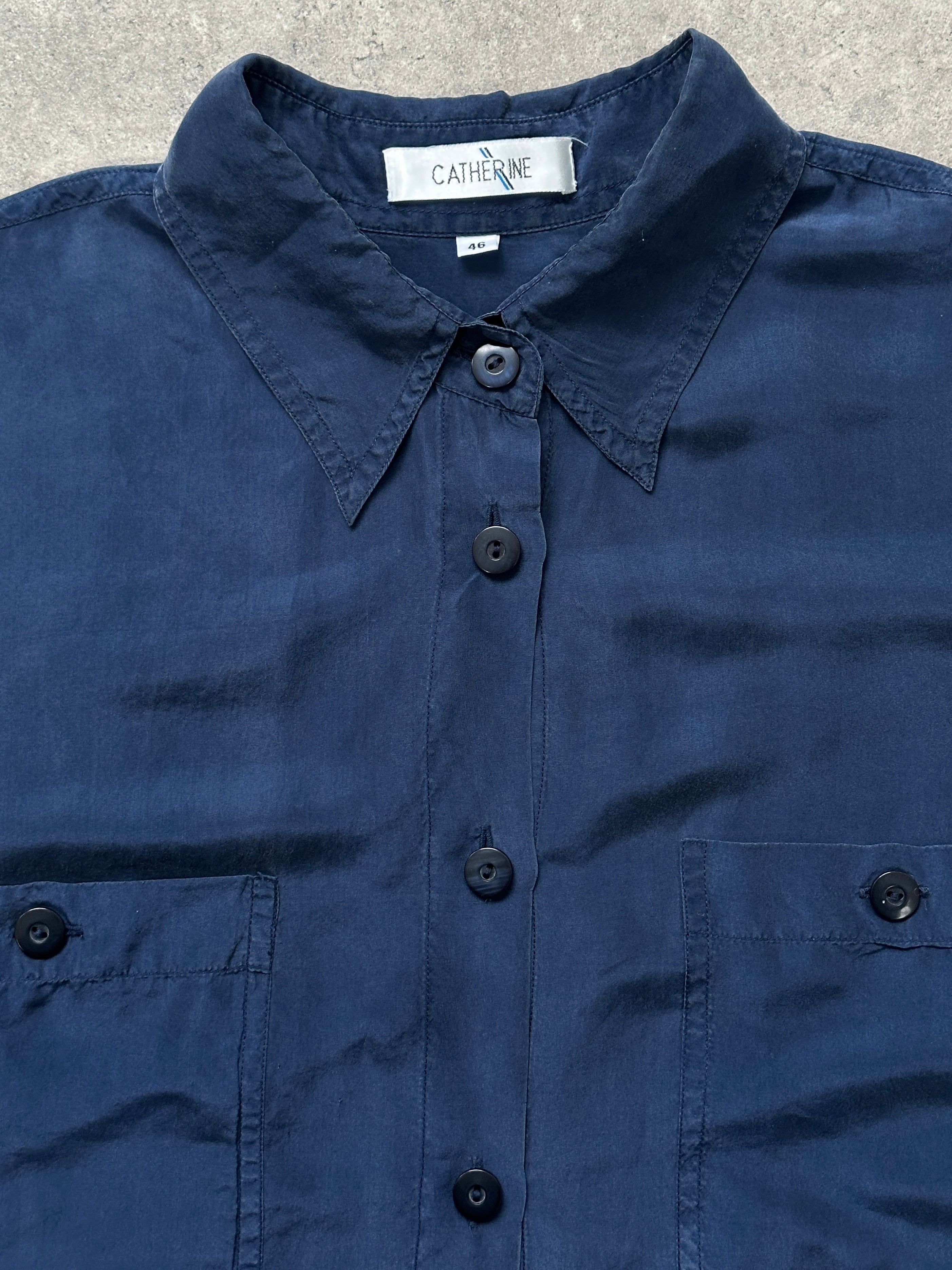 Vintage 1990s pure silk shirt in size large, featuring classic design and smooth fabric, displayed on a neutral background.
