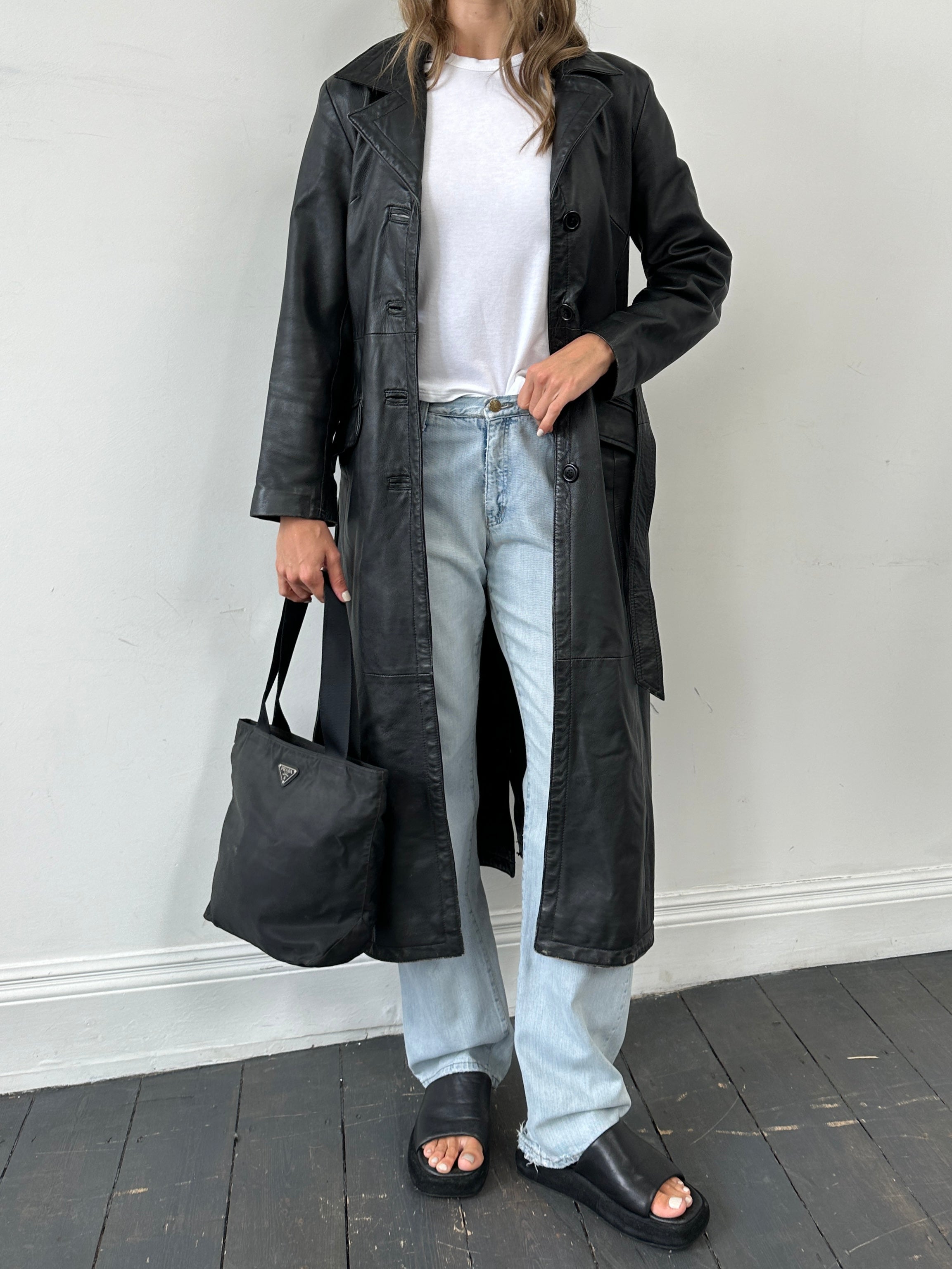 Vintage leather belted trench coat in size small, full-length jacket with classic collar and stylish vintage design.