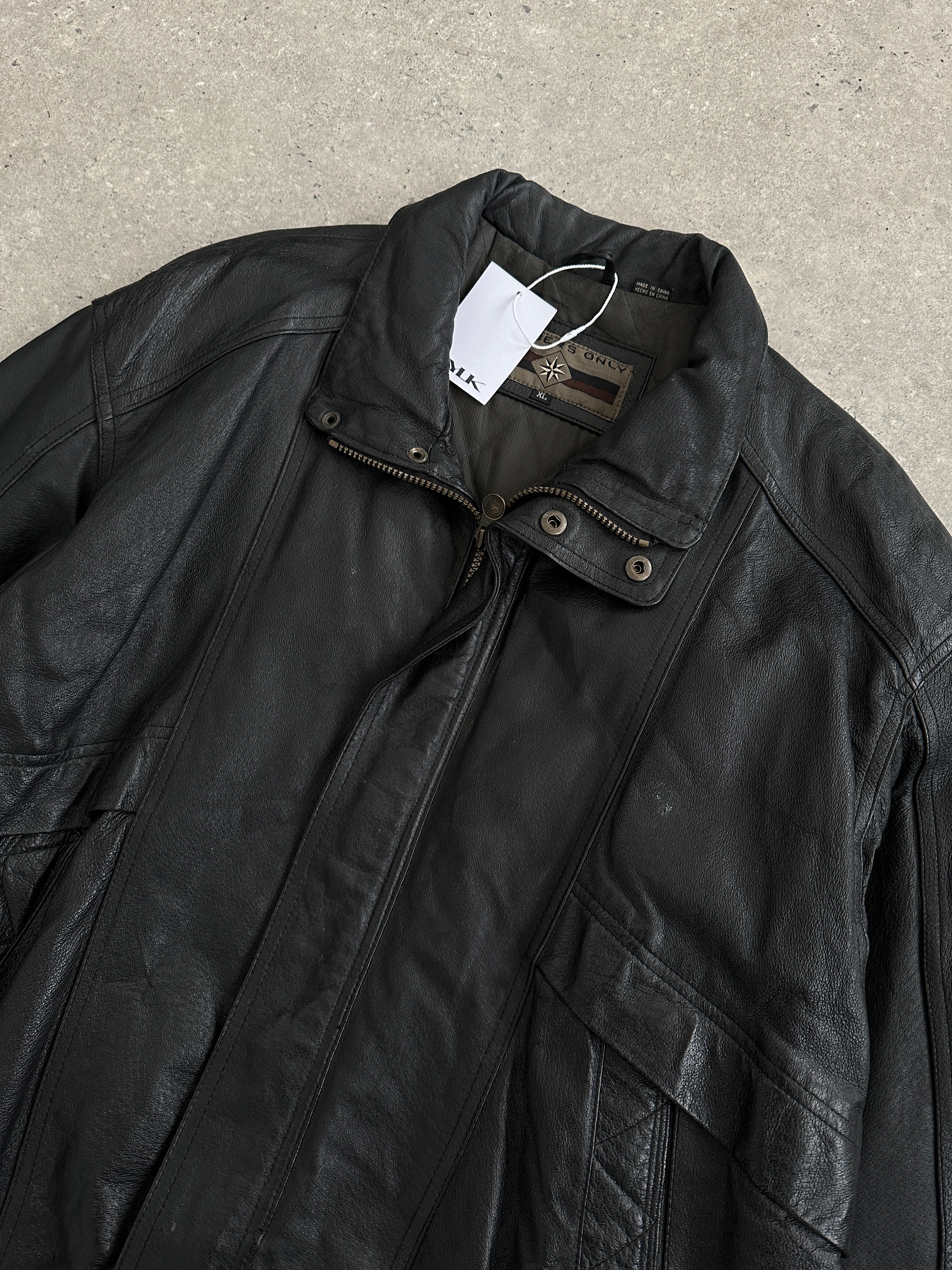 Vintage leather bomber jacket in size XL, featuring classic design with a rugged leather finish and ribbed collar and cuffs.