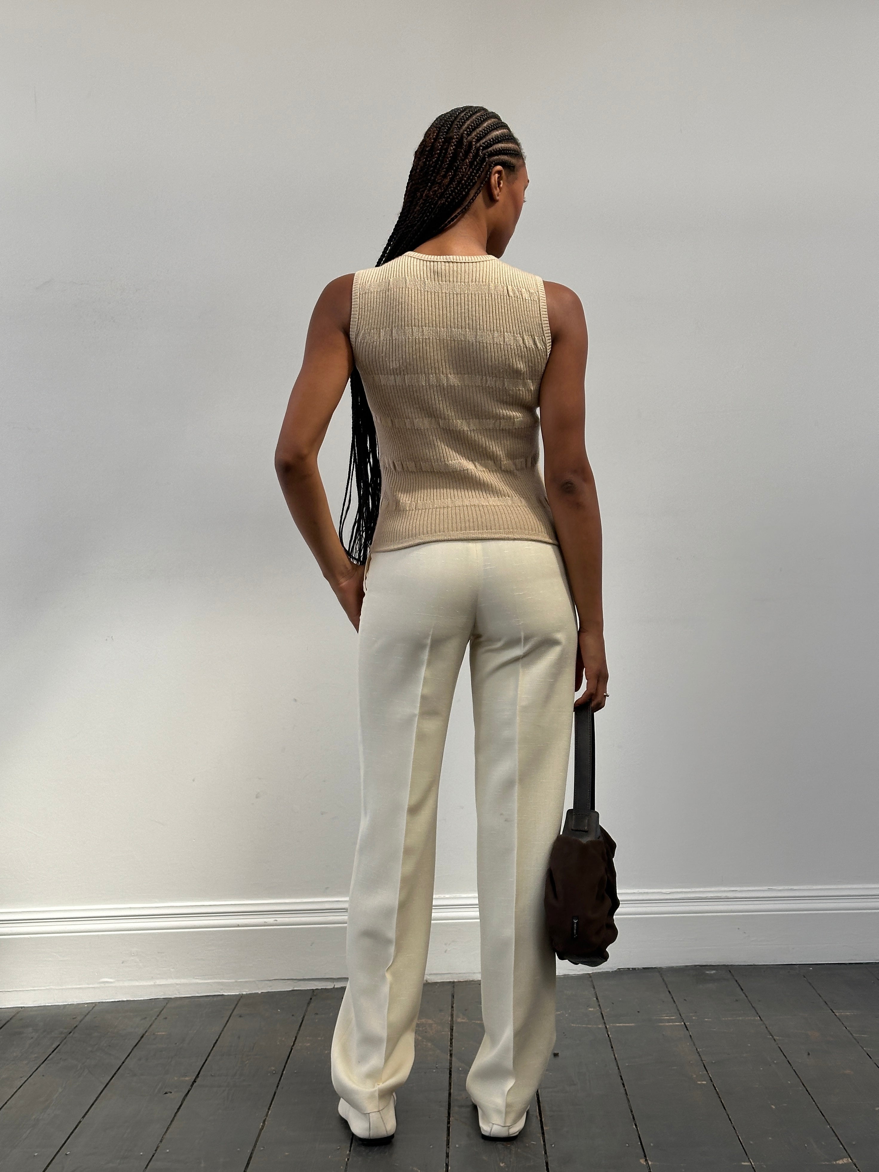 Vintage 1990s high-waisted straight-leg tailored trousers in classic neutral fabric, displayed on a hanger.