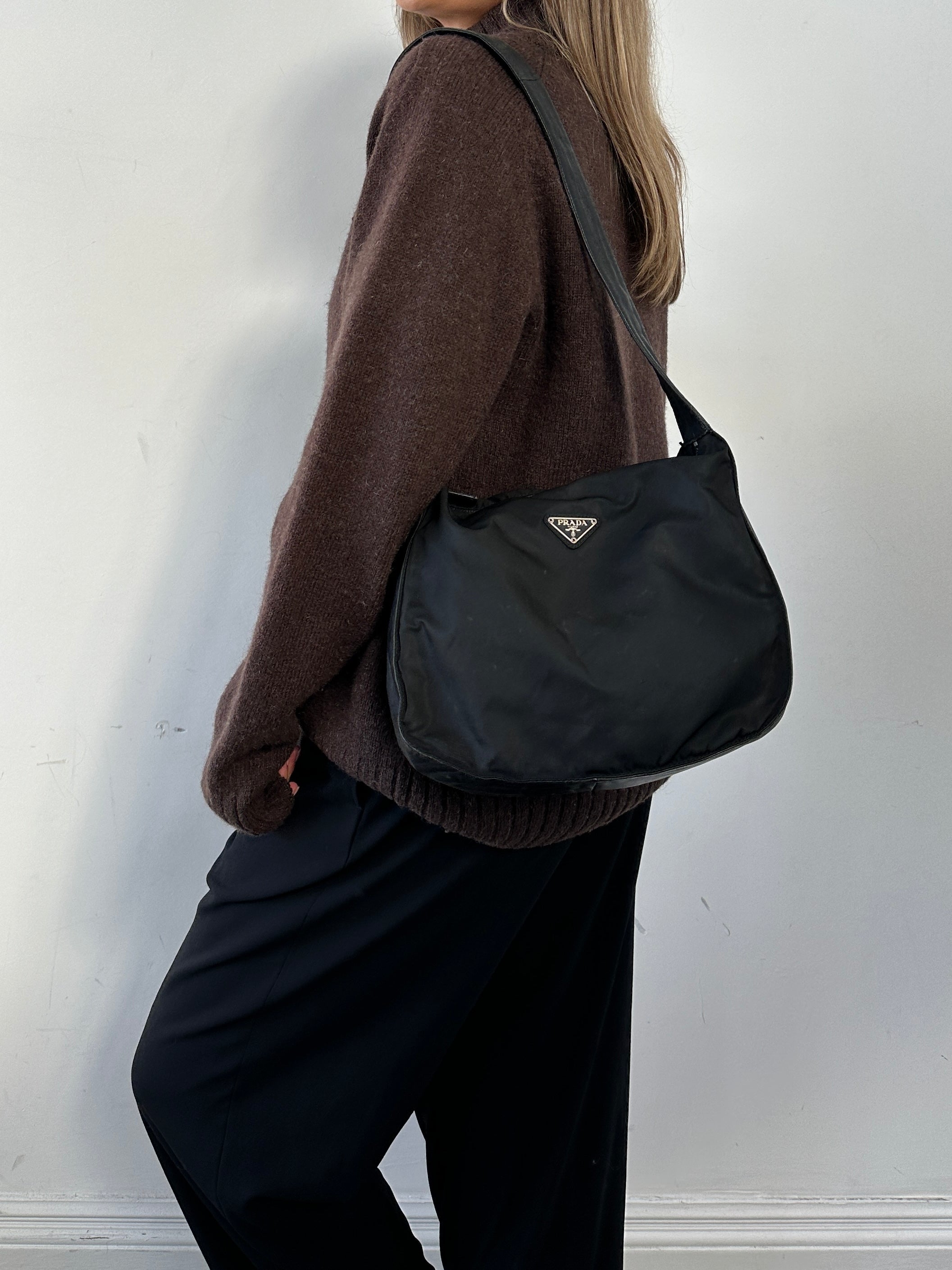 Prada nylon leather crossbody bag with adjustable strap and sleek design, featuring a minimalist style and subtle branding.