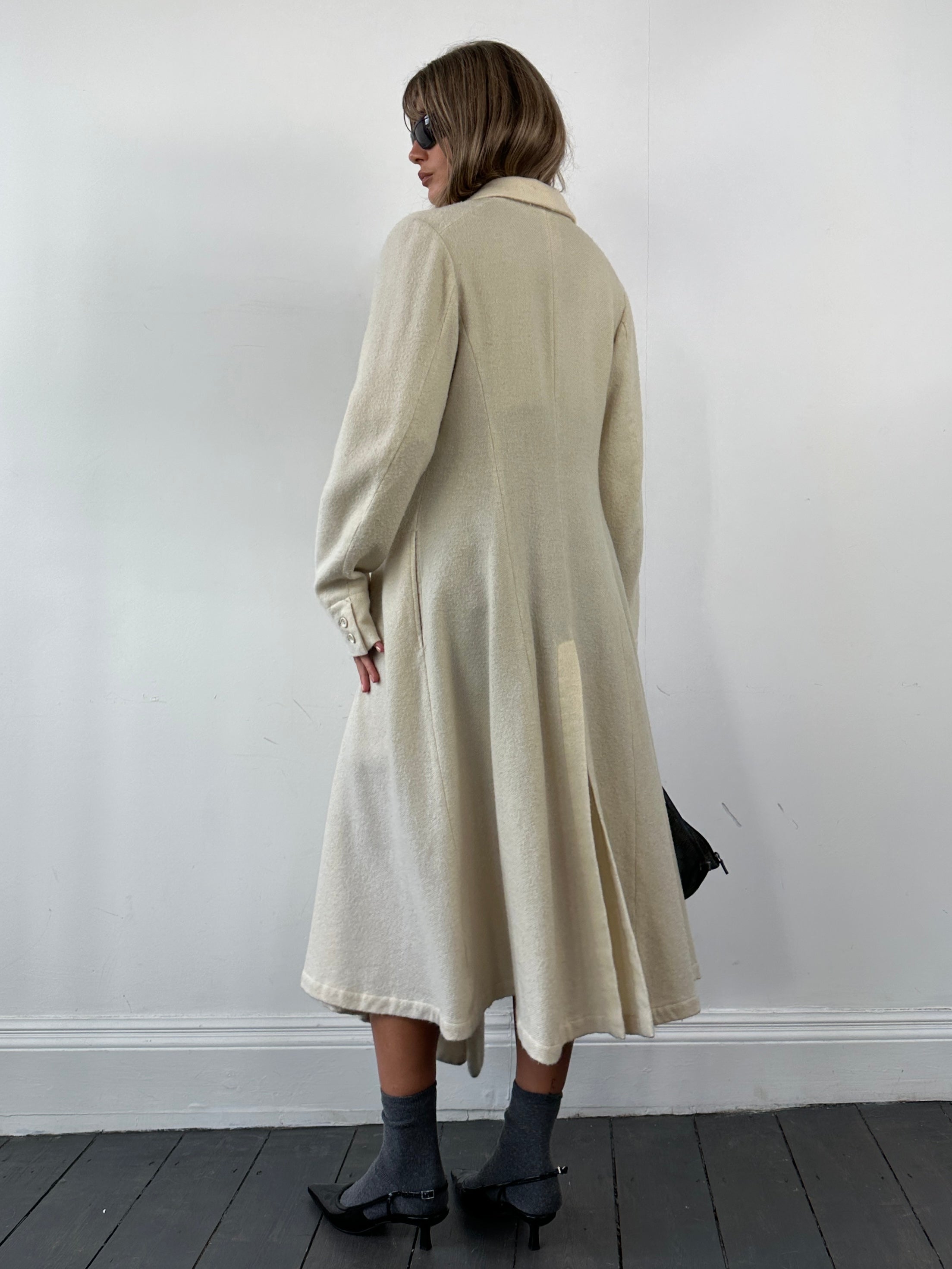 Comme des Garçons 90s unlined waterfall pure wool coat, front view showing draped collar and soft beige fabric, size M.