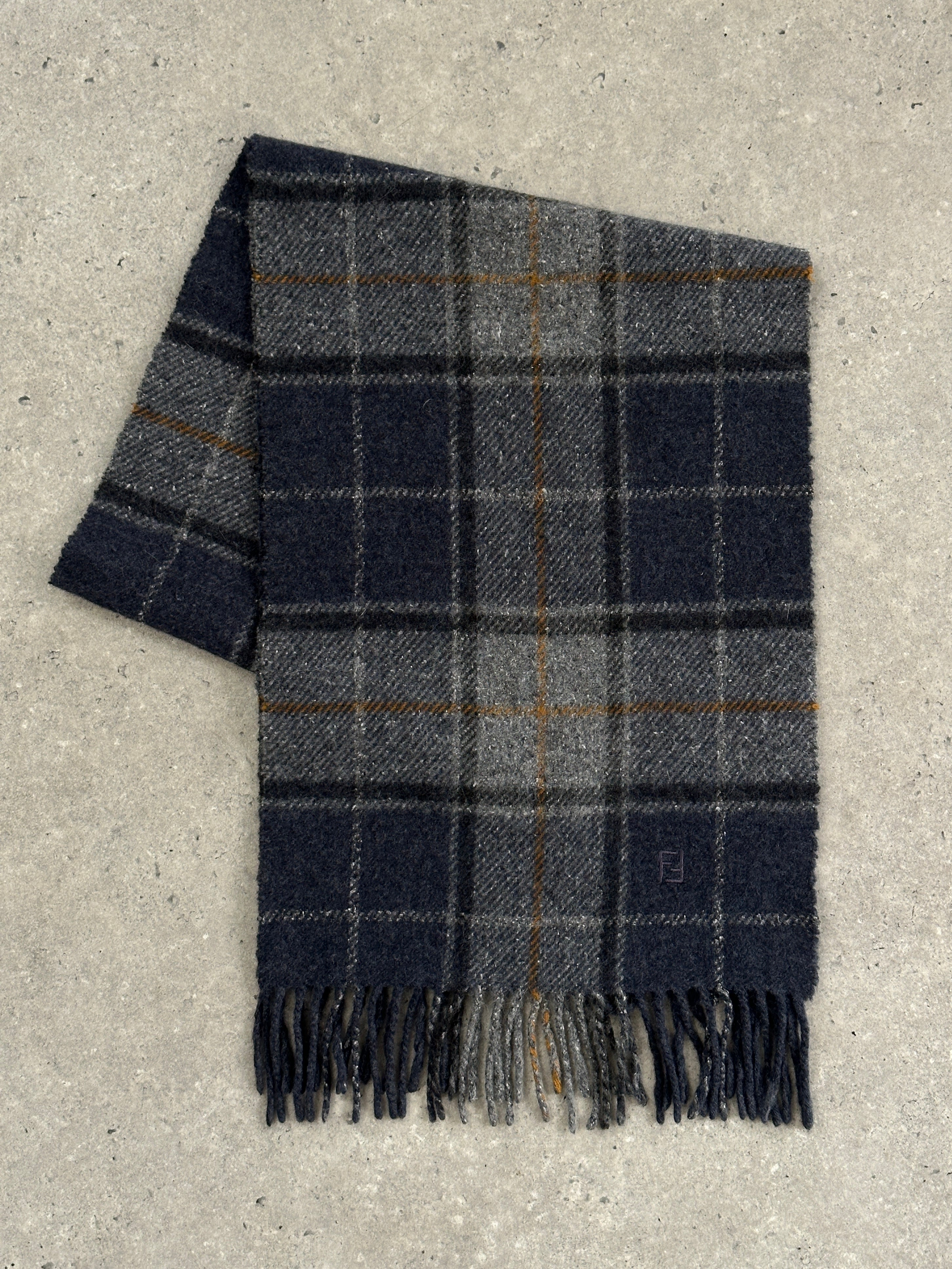 Fendi pure wool logo check scarf with classic pattern and fringed edges, stylish accessory for cold weather.