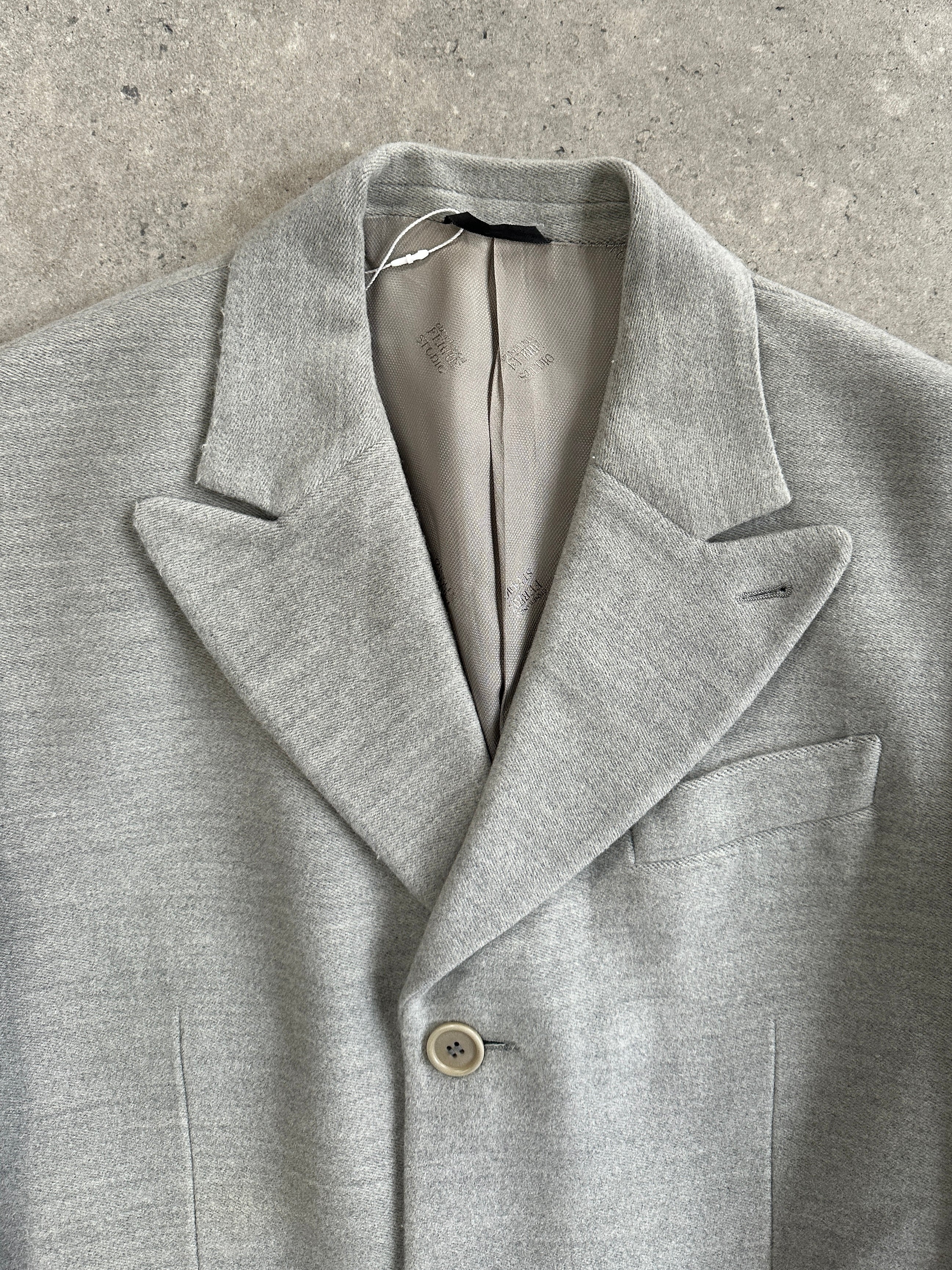 Gianfranco Ferre 1990s wool single-breasted coat in size L, shown hanging with classic tailored design and neutral color.