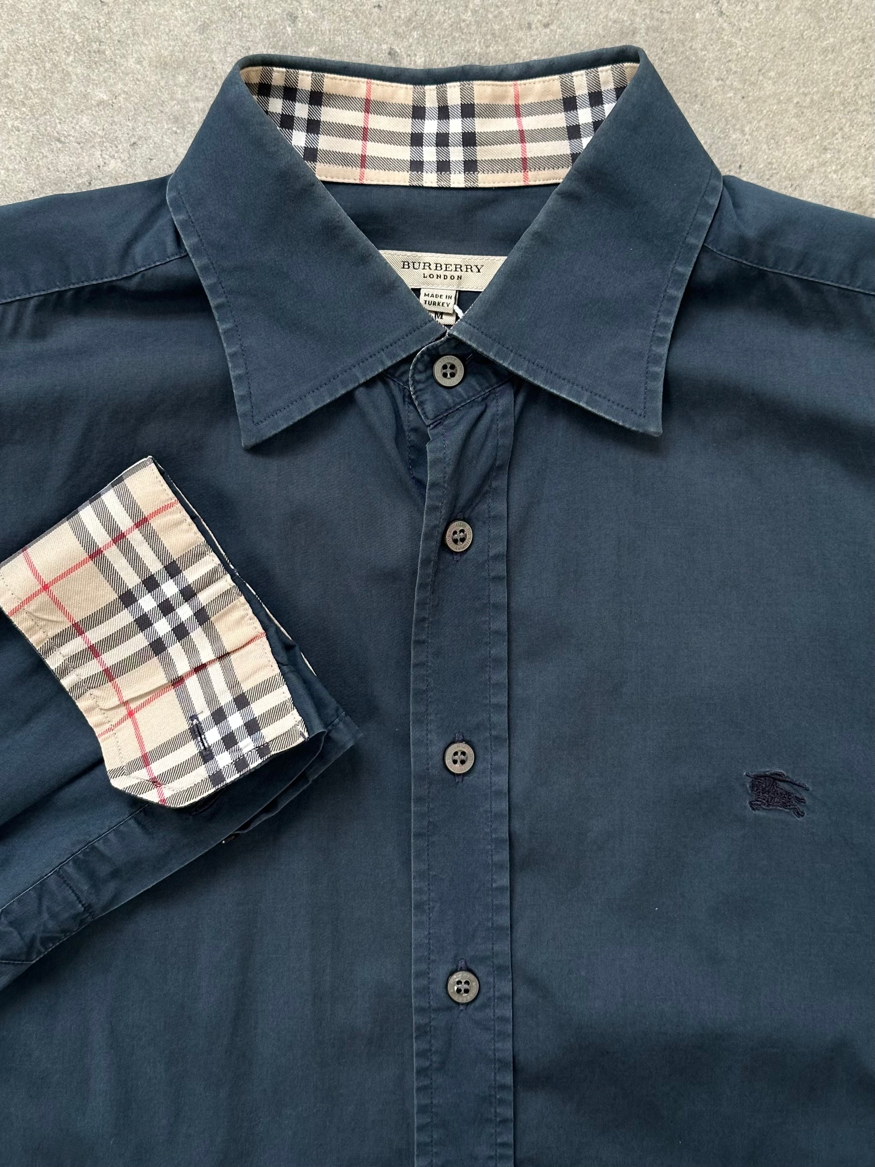 Burberry London 2000s cotton logo shirt in size M, featuring classic Burberry branding and a button-up design.