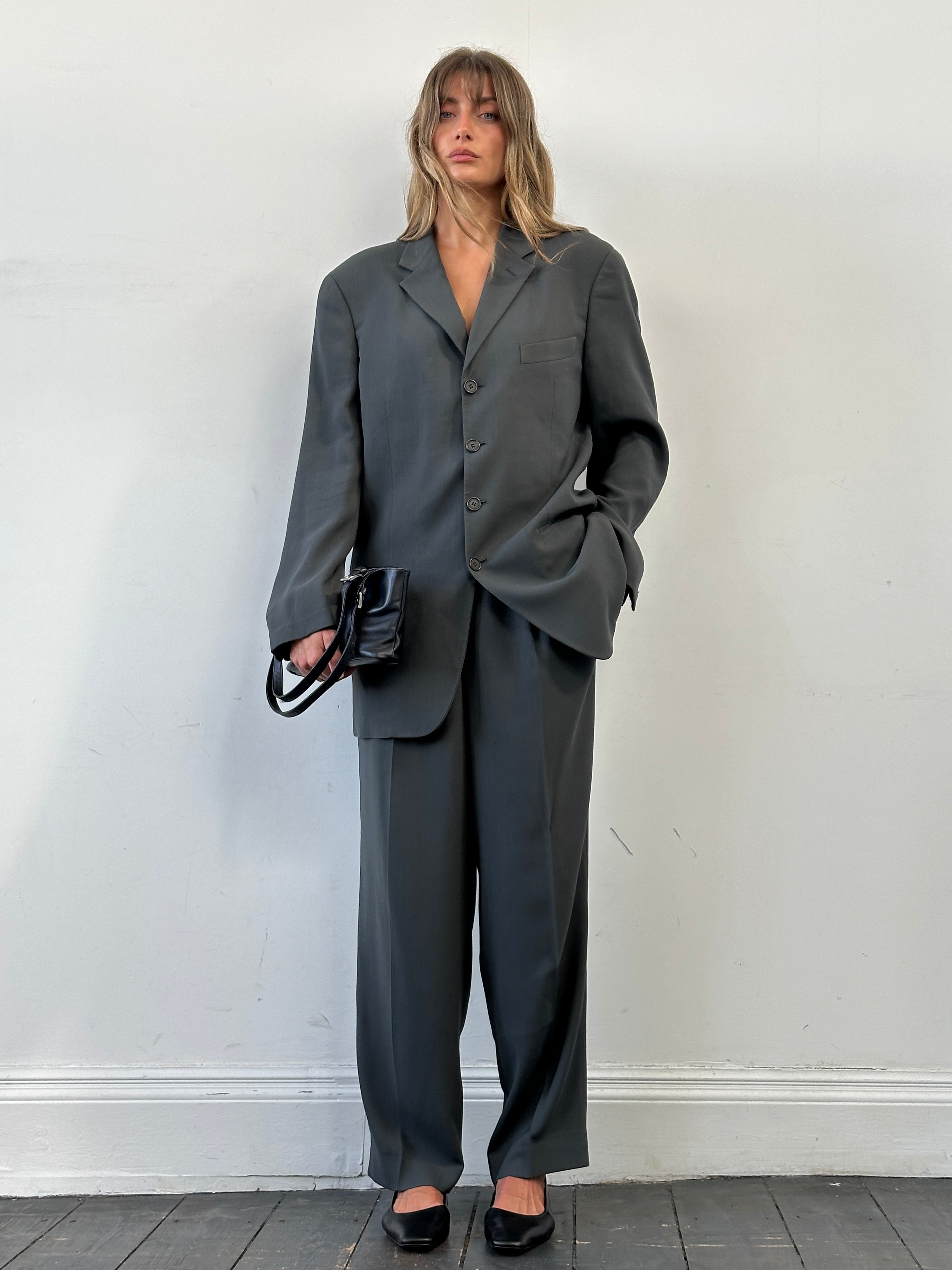 Giorgio Armani Le Collezioni wool relaxed single-breasted suit in size 42R/W34, displayed as a stylish jumpsuit on a hanger.