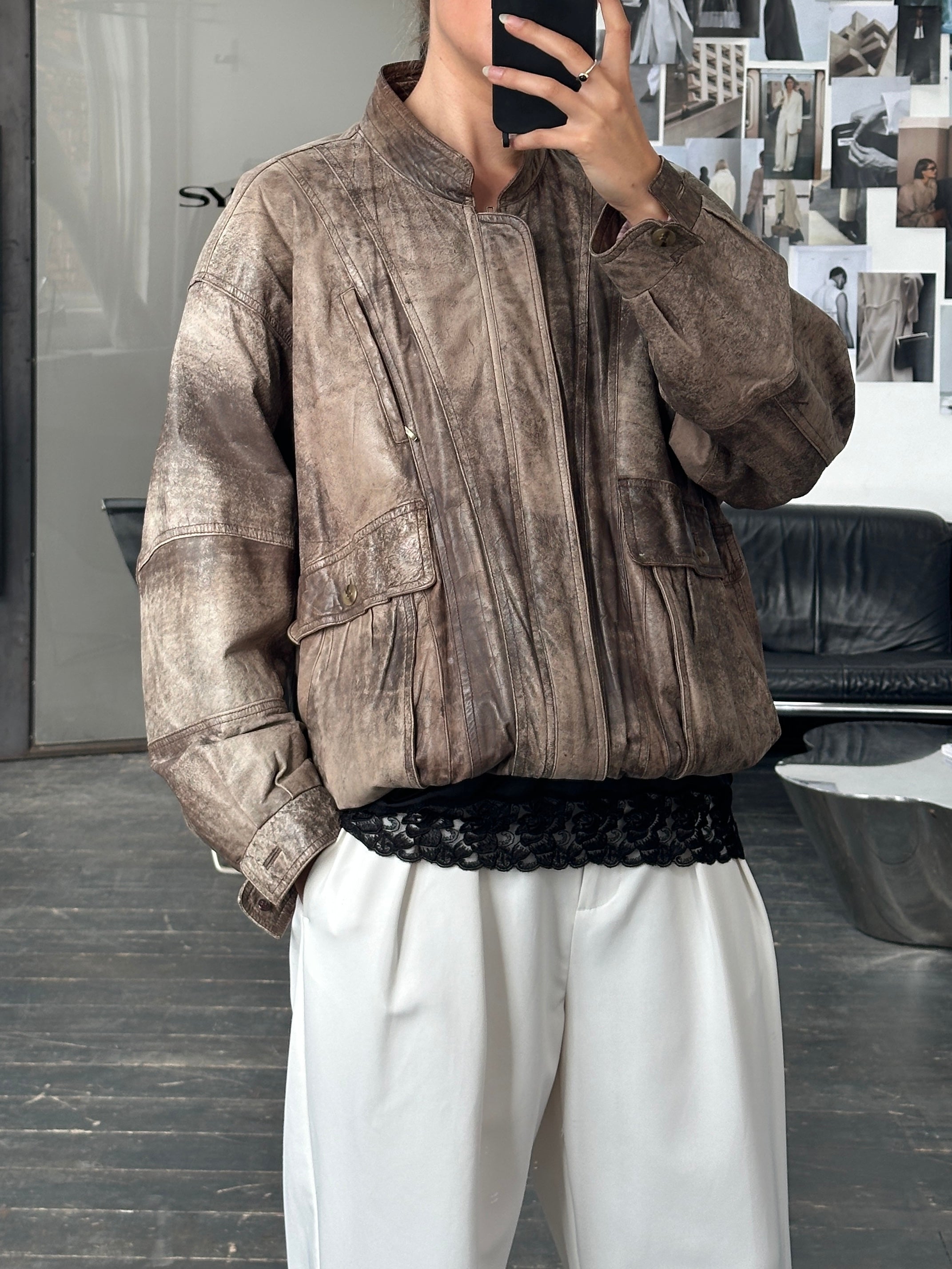 Vintage 1990s leather bomber jacket in XL size, featuring classic design and aged leather texture.