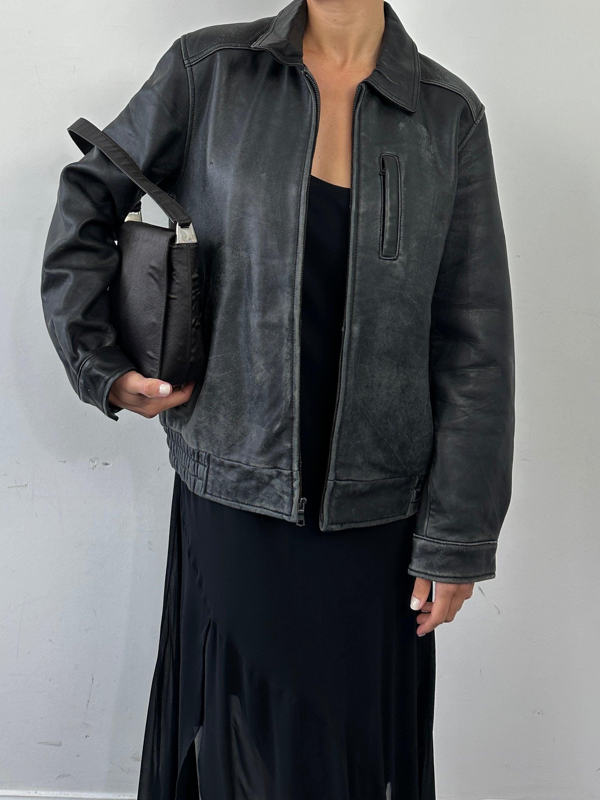 Tommy Hilfiger distressed leather bomber jacket in size M, featuring a classic design with a worn-in leather finish.