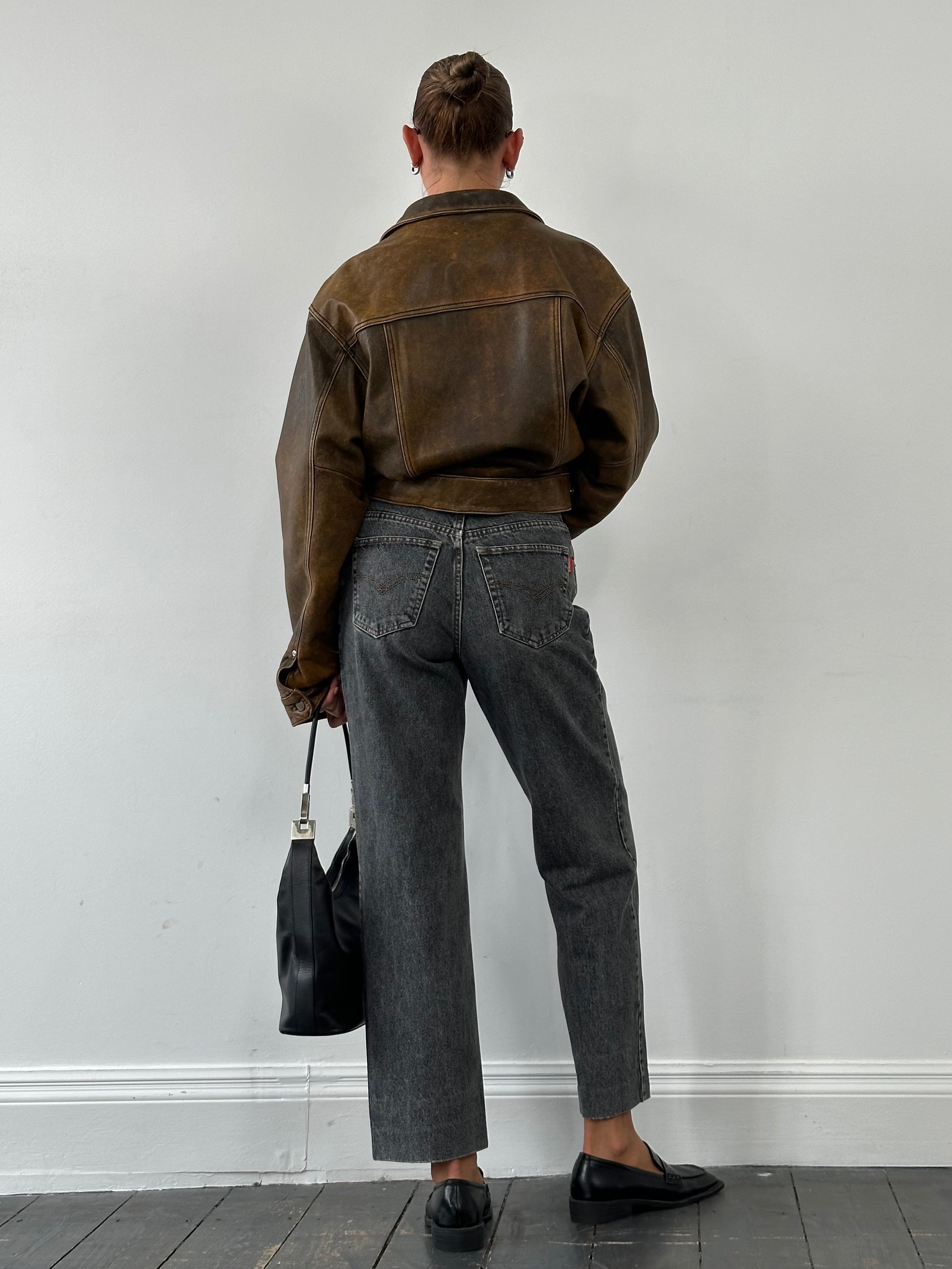 Vintage Italian 1990s high-waisted straight-leg denim jeans in W28, showcasing classic faded blue denim and vintage style.
