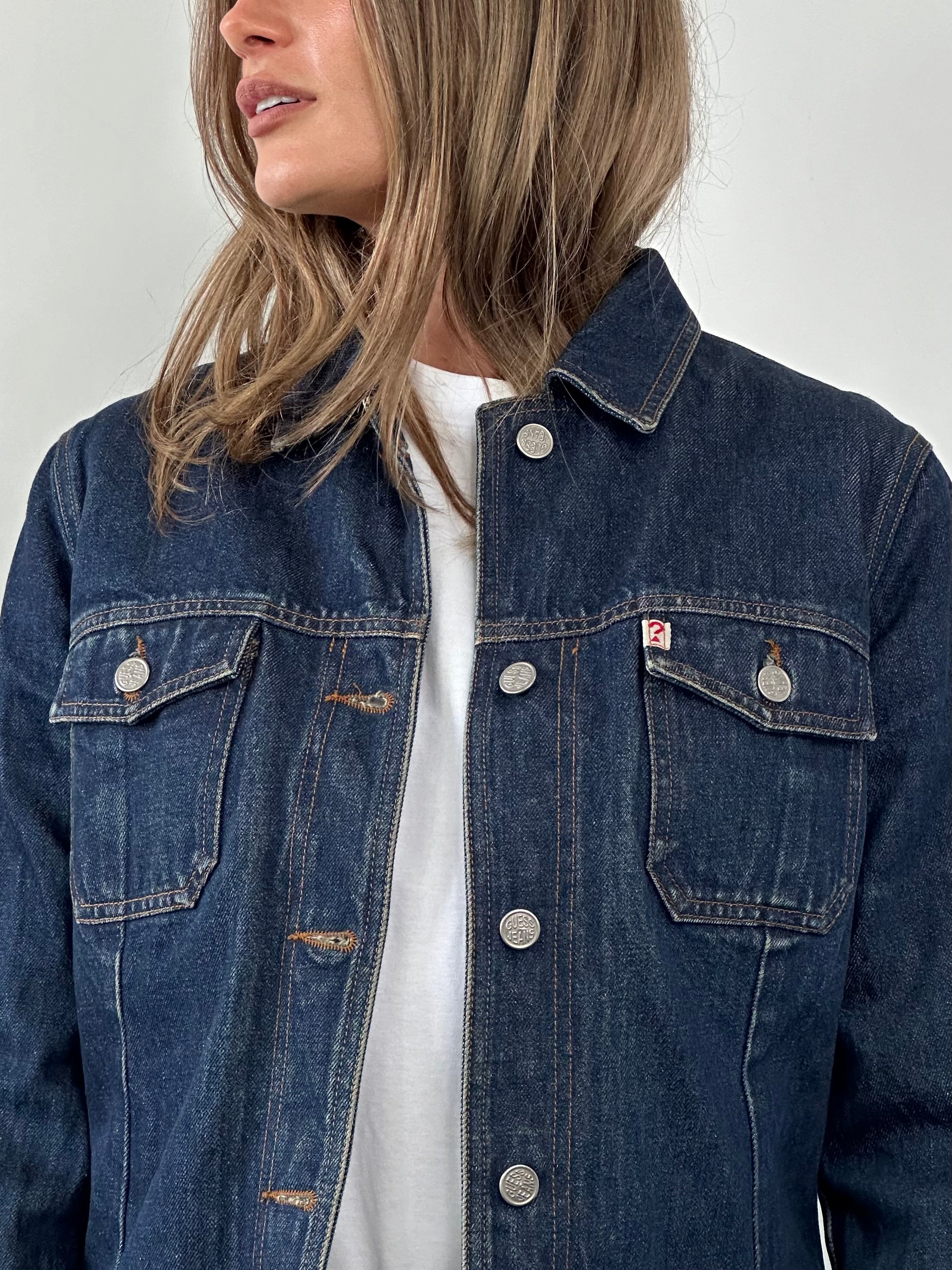 Guess contrast stitch denim jacket in size S/M, featuring classic blue denim, button closure, and stylish contrast stitching.
