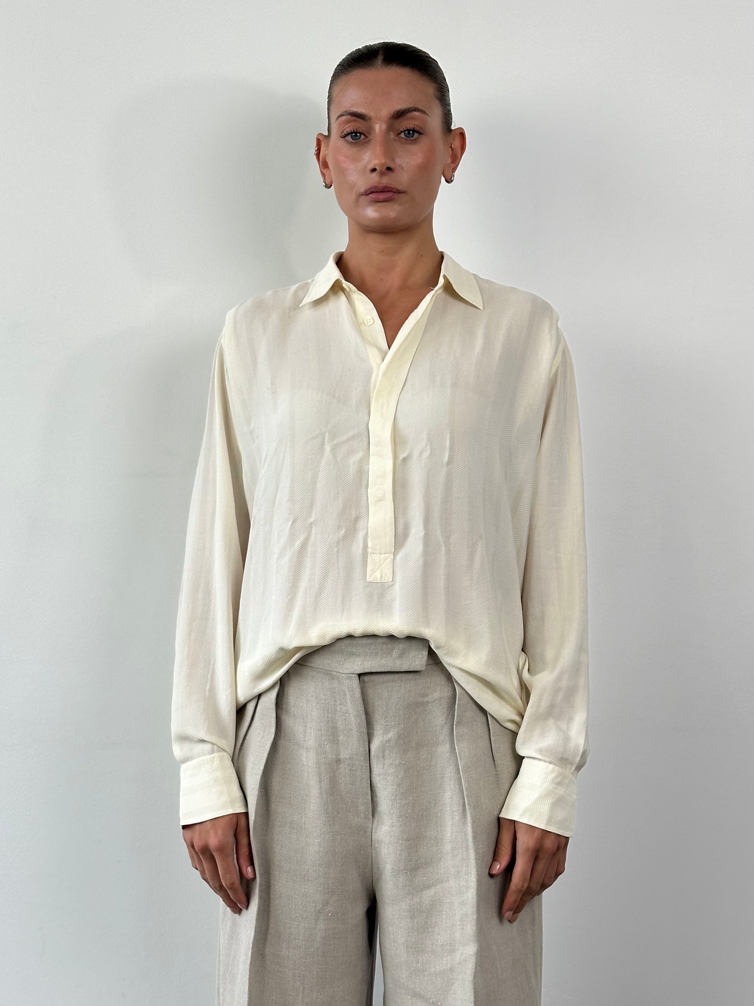 Vintage pure silk polo shirt in size L/XL, showcasing a classic design with a smooth silk fabric and a collar.