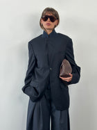 Loro Piana Rene Lezard 2000s high-neck wool blazer, single-breasted, in size 40L/L, displayed on a hanger showing its tailored fit.