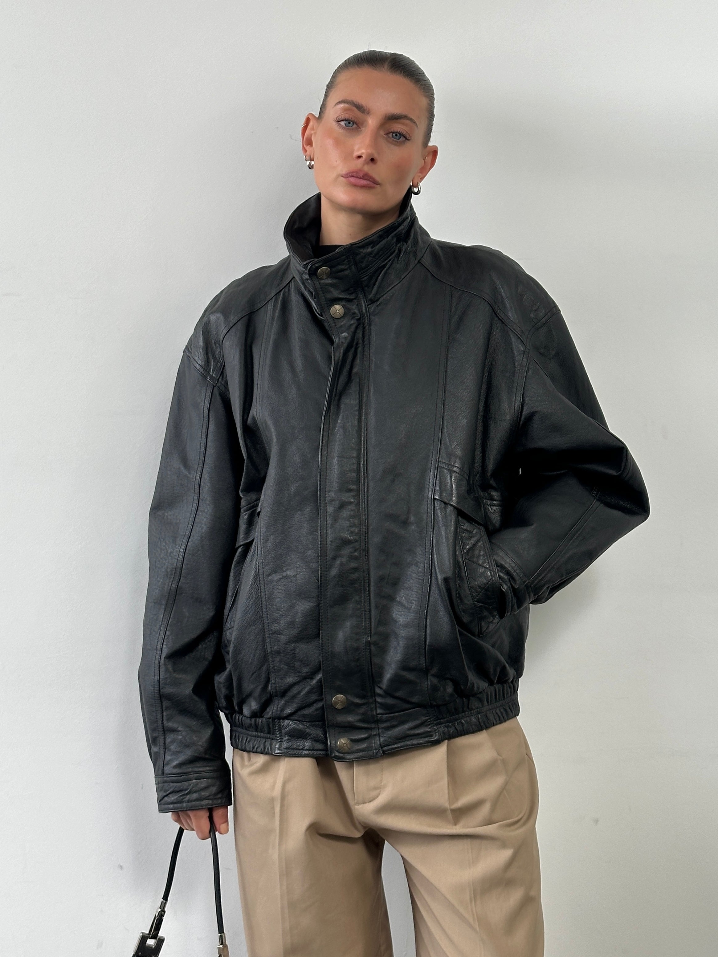 Vintage high neck leather bomber jacket in XL, featuring a classic design, smooth leather finish, and ribbed cuffs and collar.