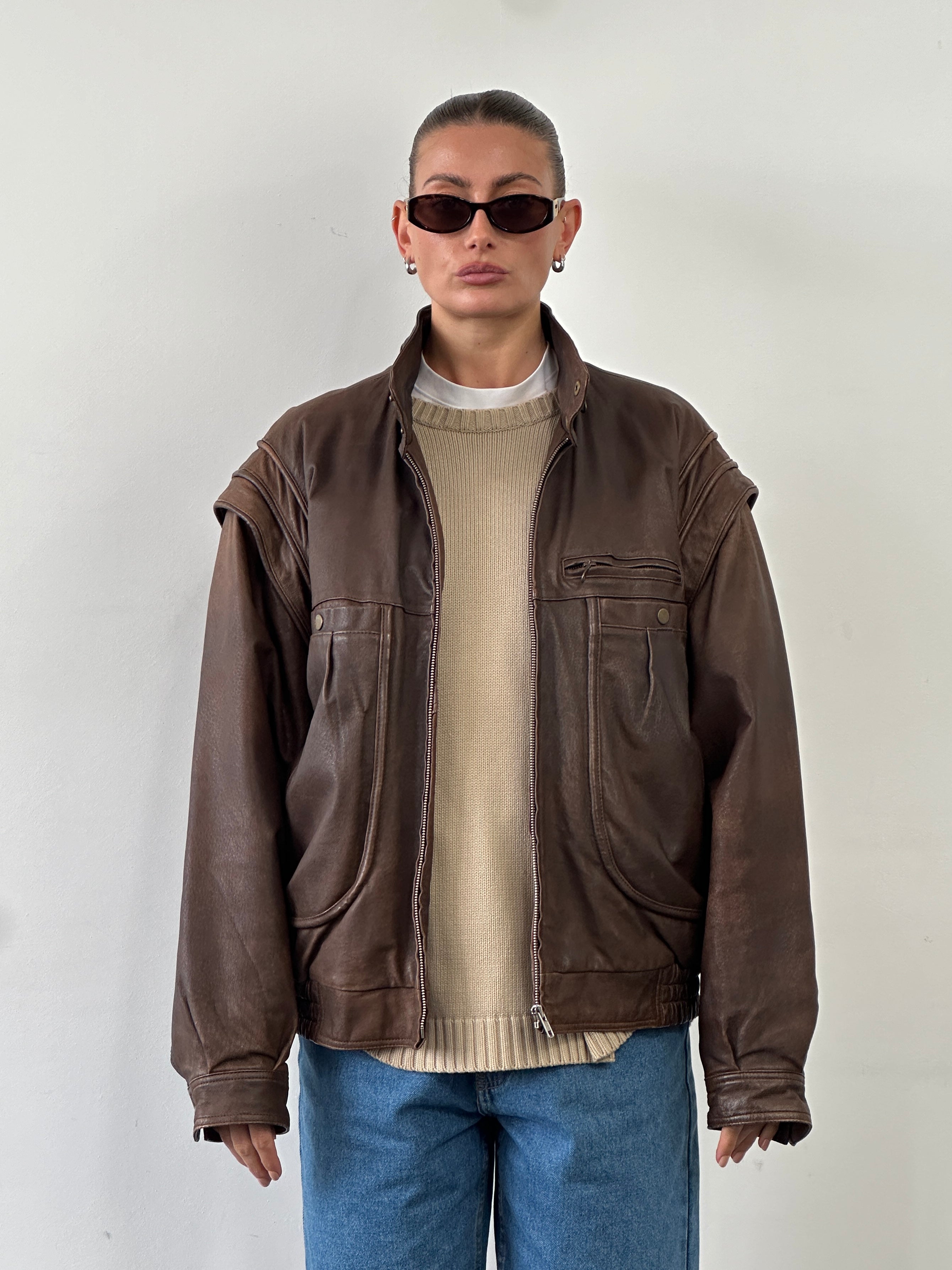 Vintage high neck aged leather bomber jacket in size L/XL, featuring a classic design with rugged leather and a vintage finish.