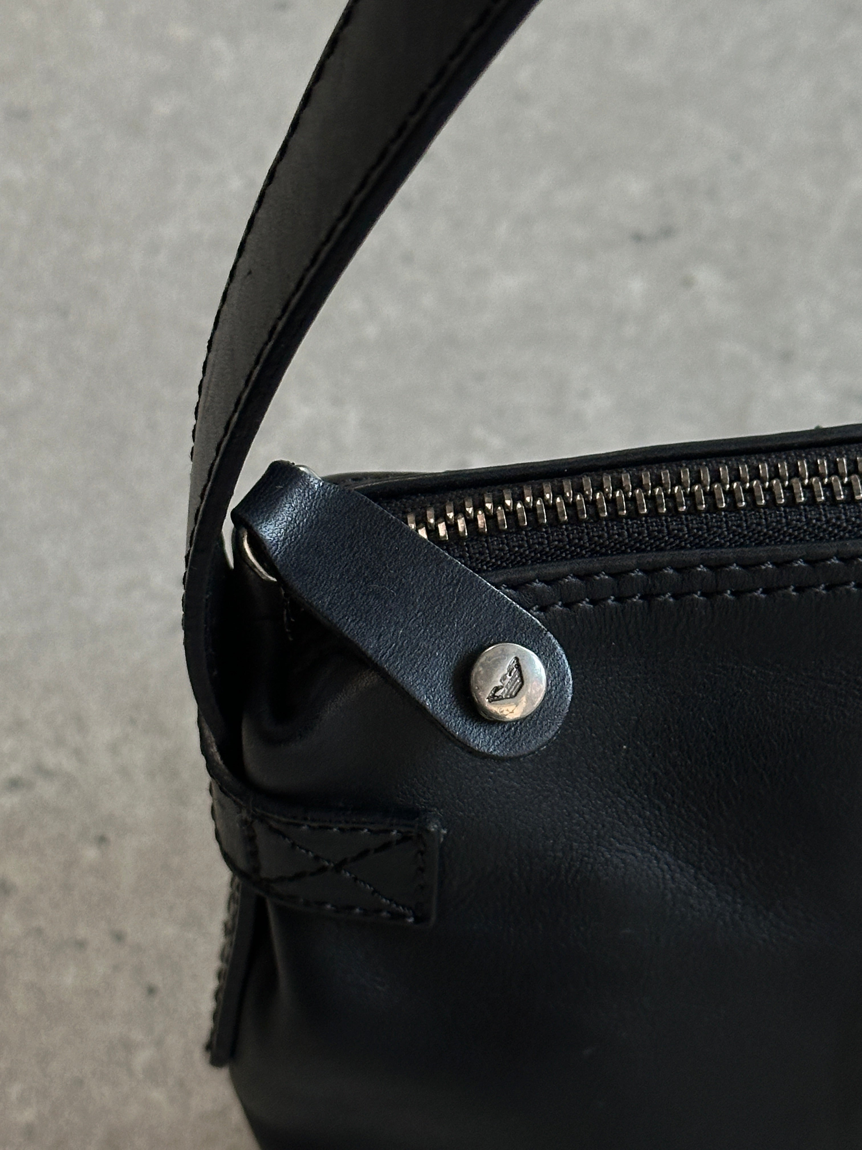 Emporio Armani 2000s leather shoulder bag with sleek design and subtle branding, featuring a shoulder strap and textured leather surface.