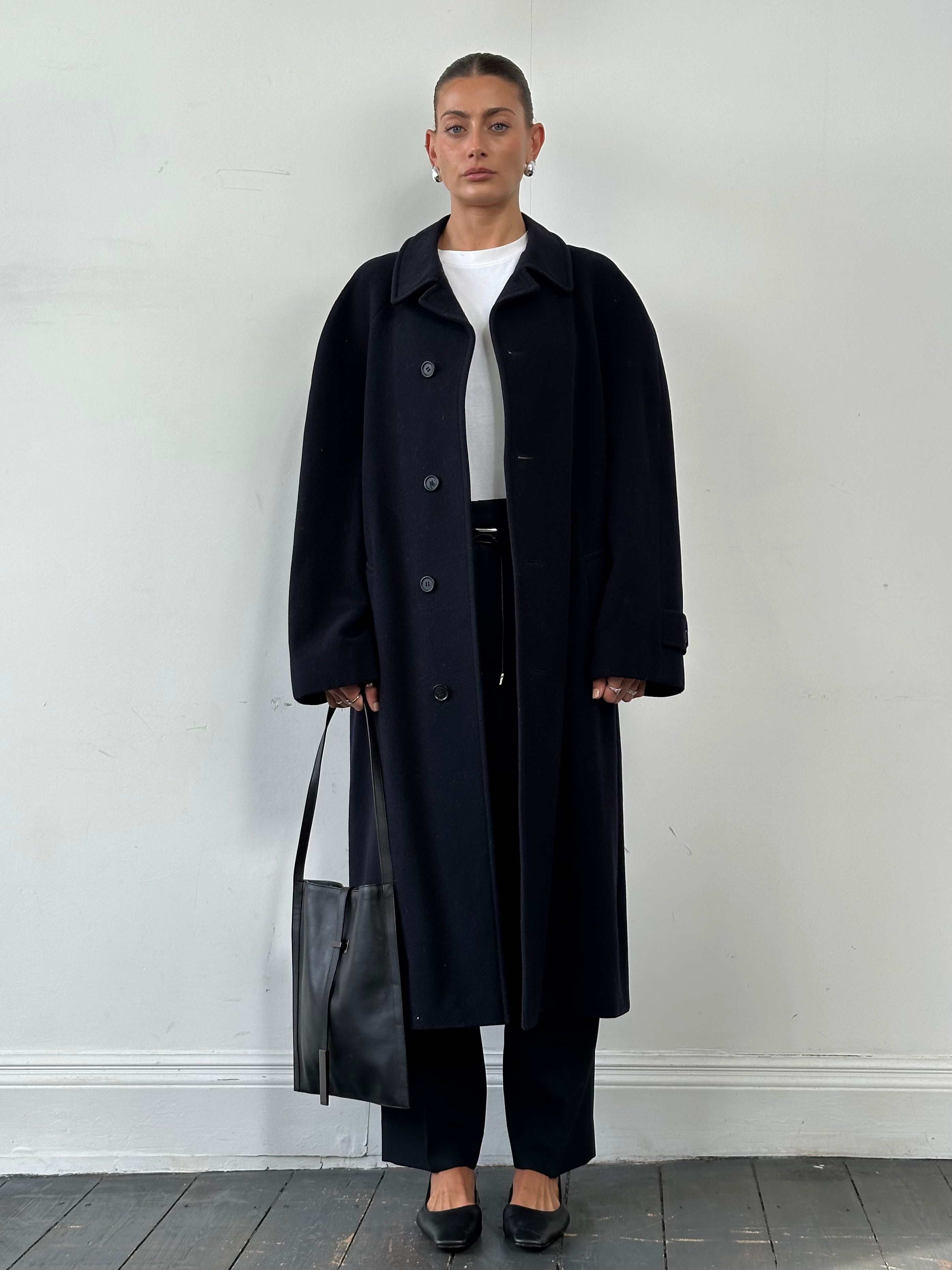 Yves Saint Laurent Pour Homme wool cashmere single-breasted coat in XL, dark-colored fabric, shown hanging on a clothing rack.