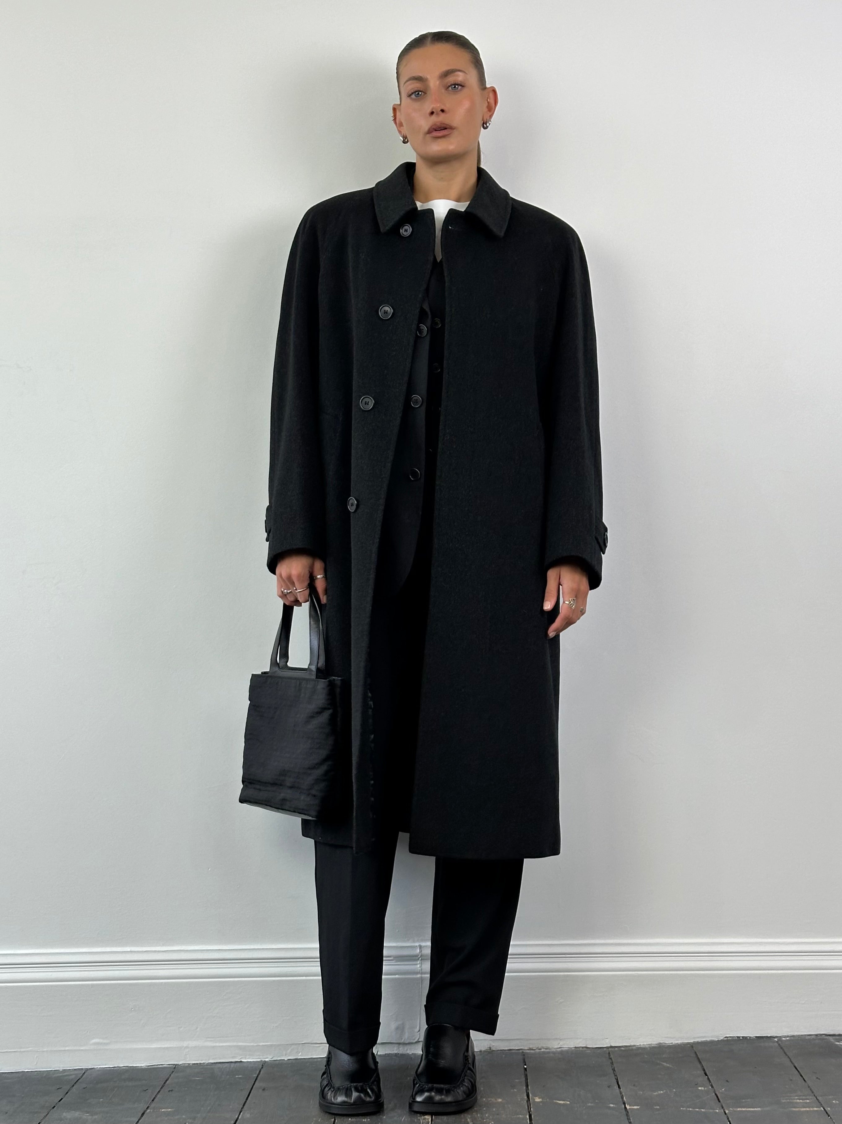 Loro Piana Viola XL coat made of pure virgin wool with a concealed placket and tailored fit, displayed on a hanger.