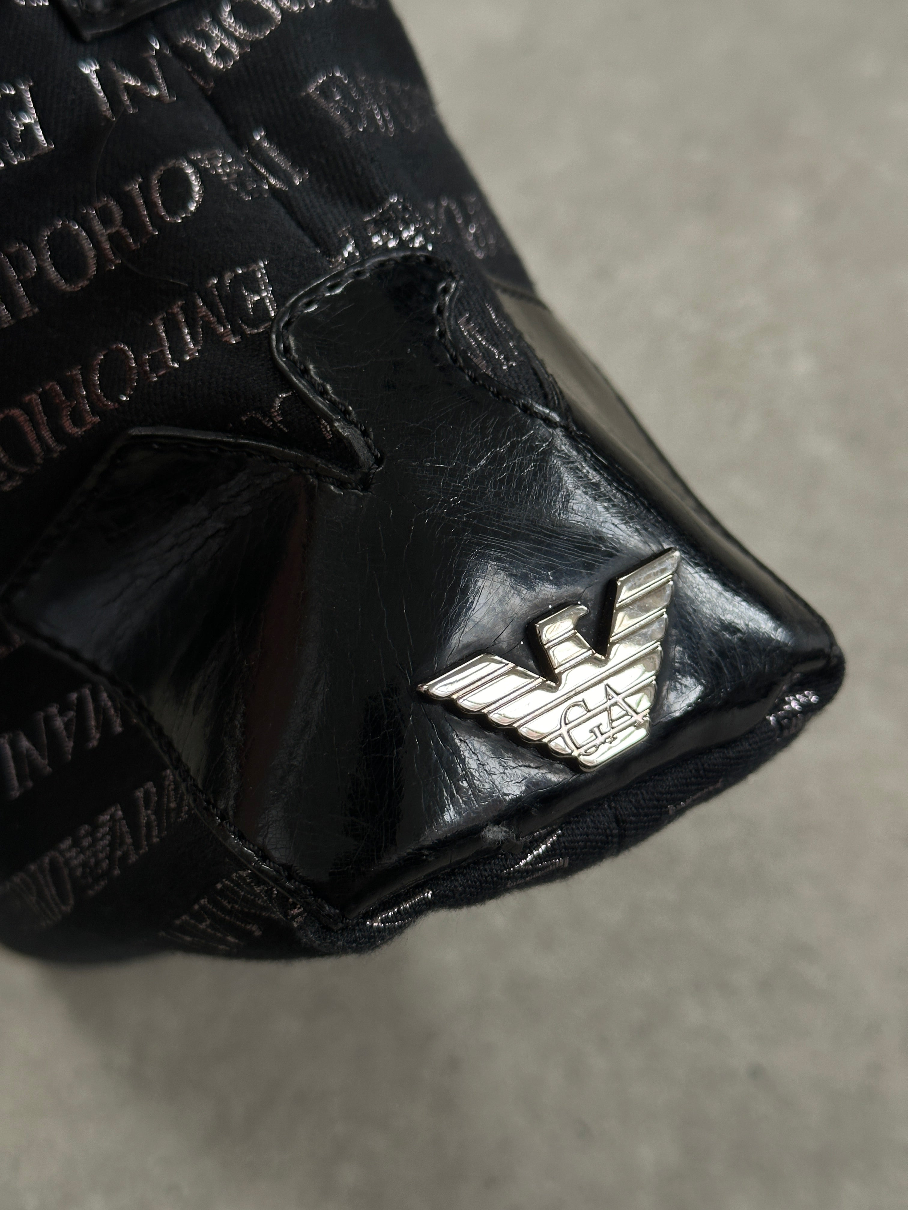 Emporio Armani Monogram shoulder bag featuring designer monogram pattern, sleek leather strap, and elegant craftsmanship.