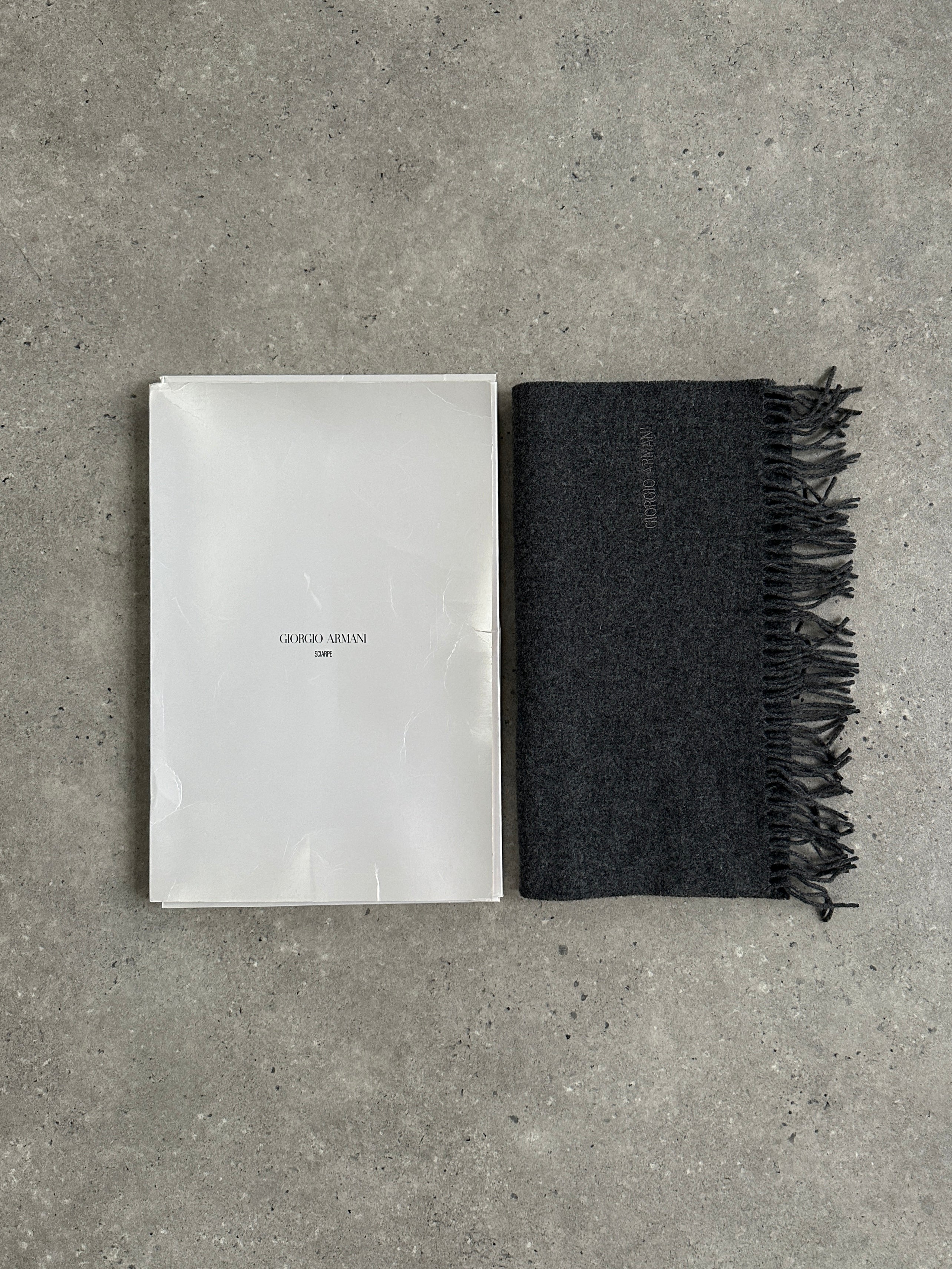 Giorgio Armani Le Collezioni pure wool logo scarf in neutral tones, showcasing soft fabric and subtle brand emblem detail.