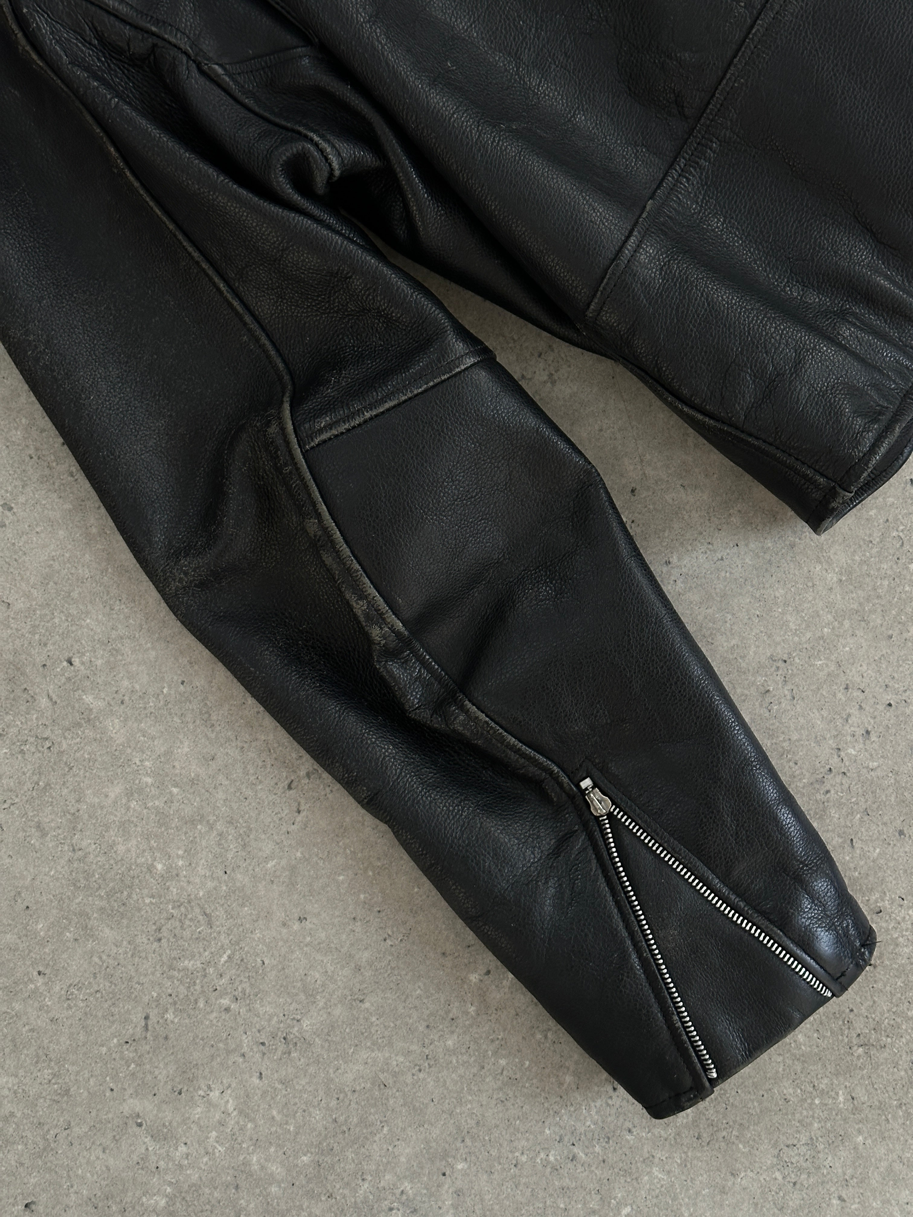 Vintage leather biker jacket in XL size, featuring classic design with distressed detailing and metal hardware.