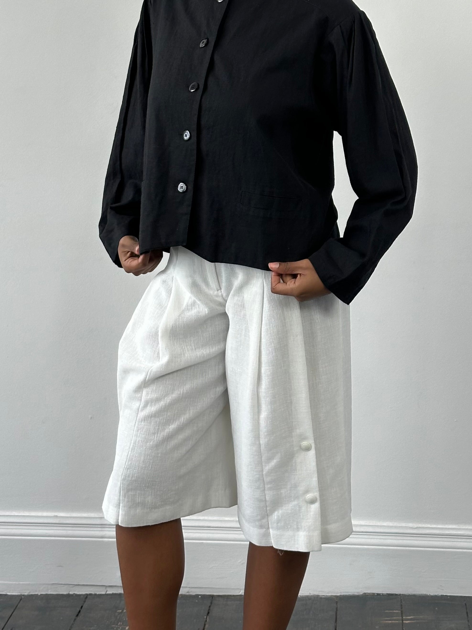 Vintage Japanese 1990s high-waisted pleated culottes shorts in a vintage style, with a relaxed fit and pleated design.