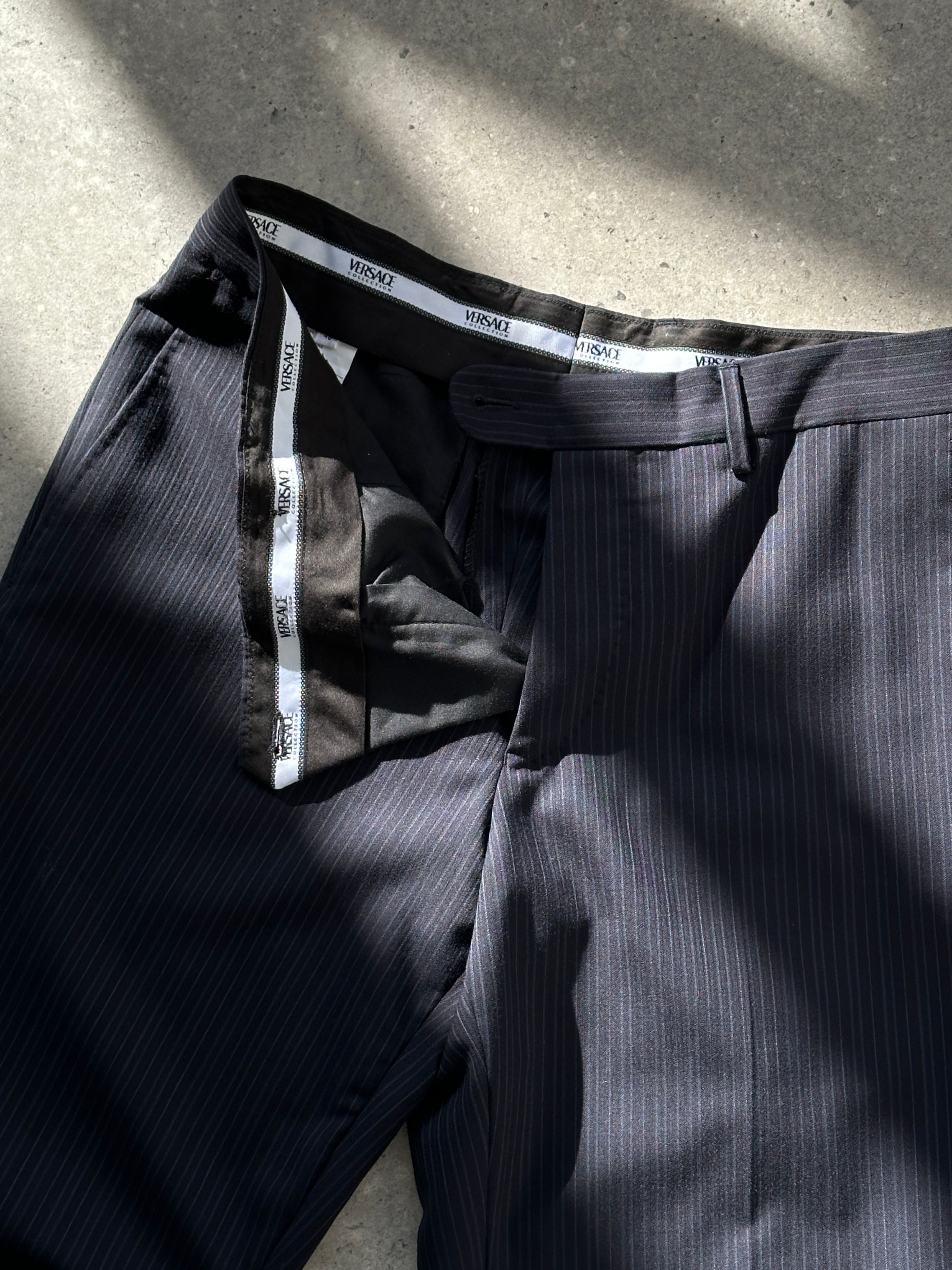 Versace Collection wool pinstripe tailored trousers with a classic fit, featuring a sharp waistband and tailored leg design.