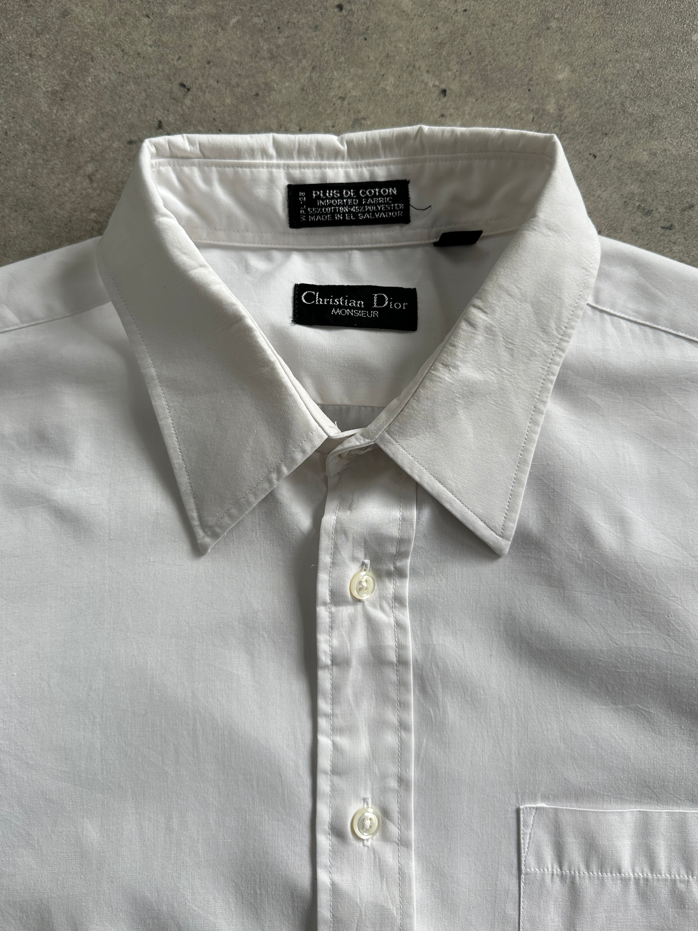Christian Dior Monsieur cotton shirt in size L/XL, featuring a classic design and smooth fabric, showcased on a hanger.