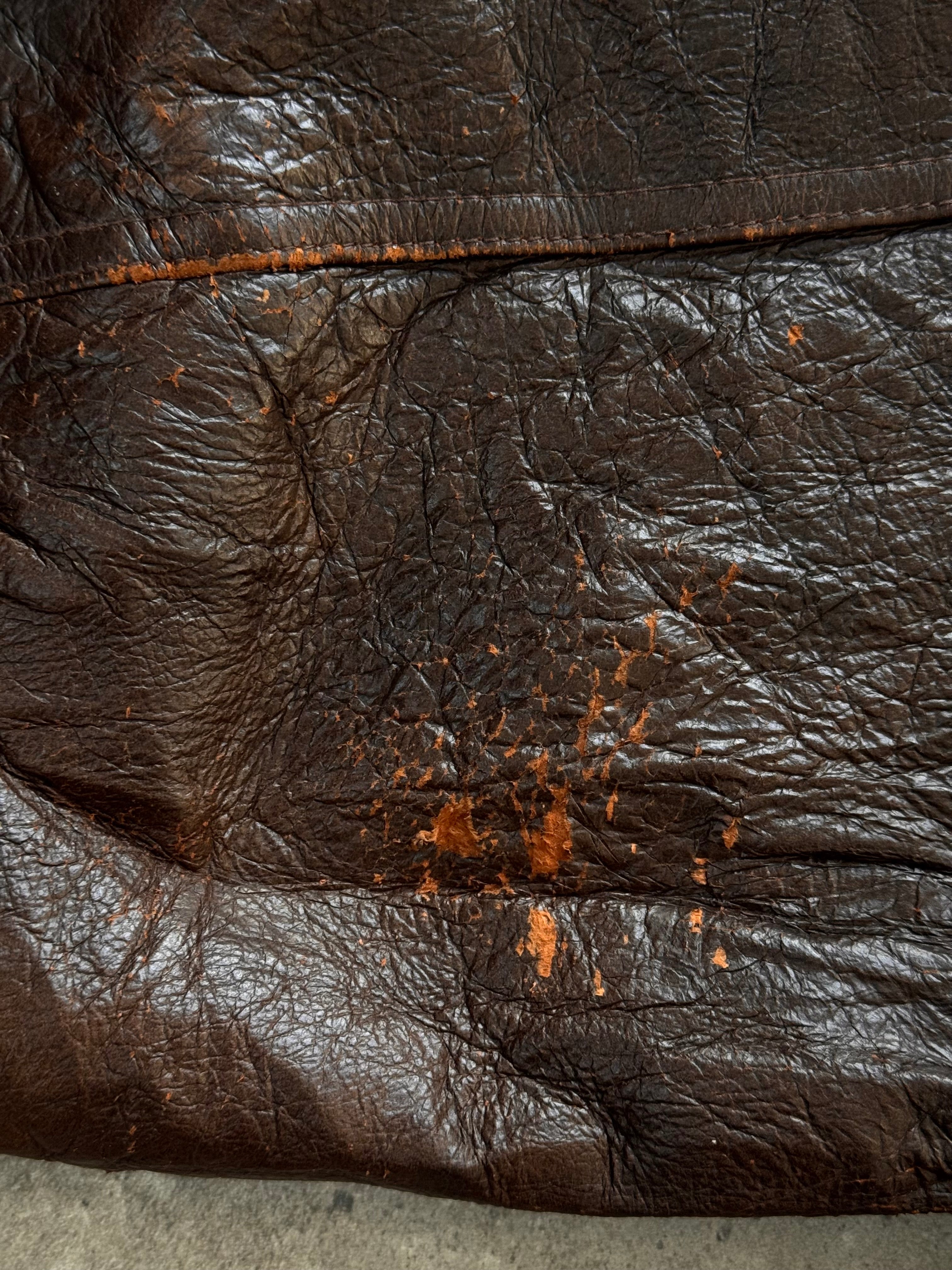Vintage 1990s distressed leather bomber jacket, XL size, showcasing rugged leather texture and classic bomber style.