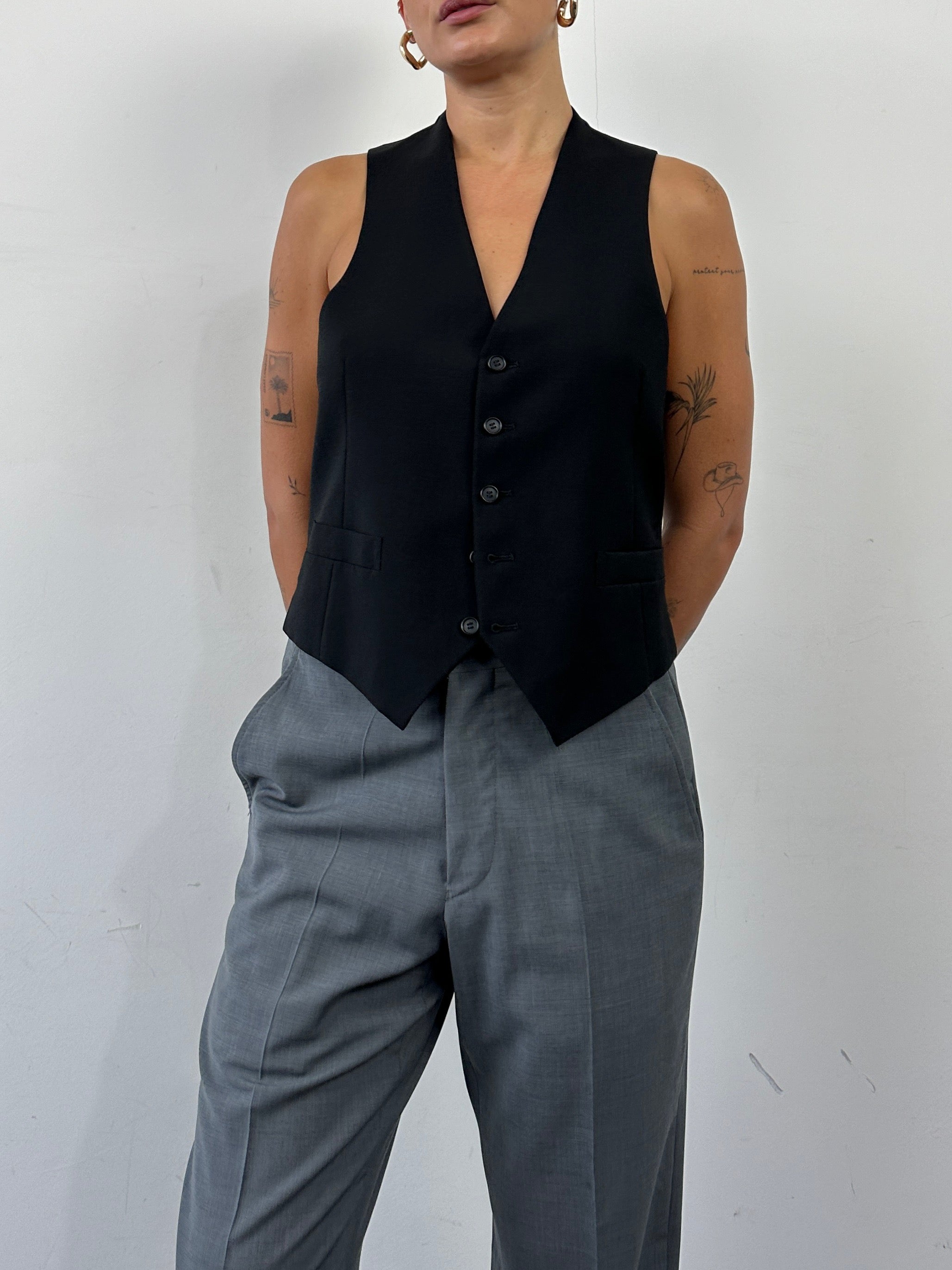 Vintage pure wool tailored waistcoat in size L, featuring classic design and detailed stitching, on a plain background.