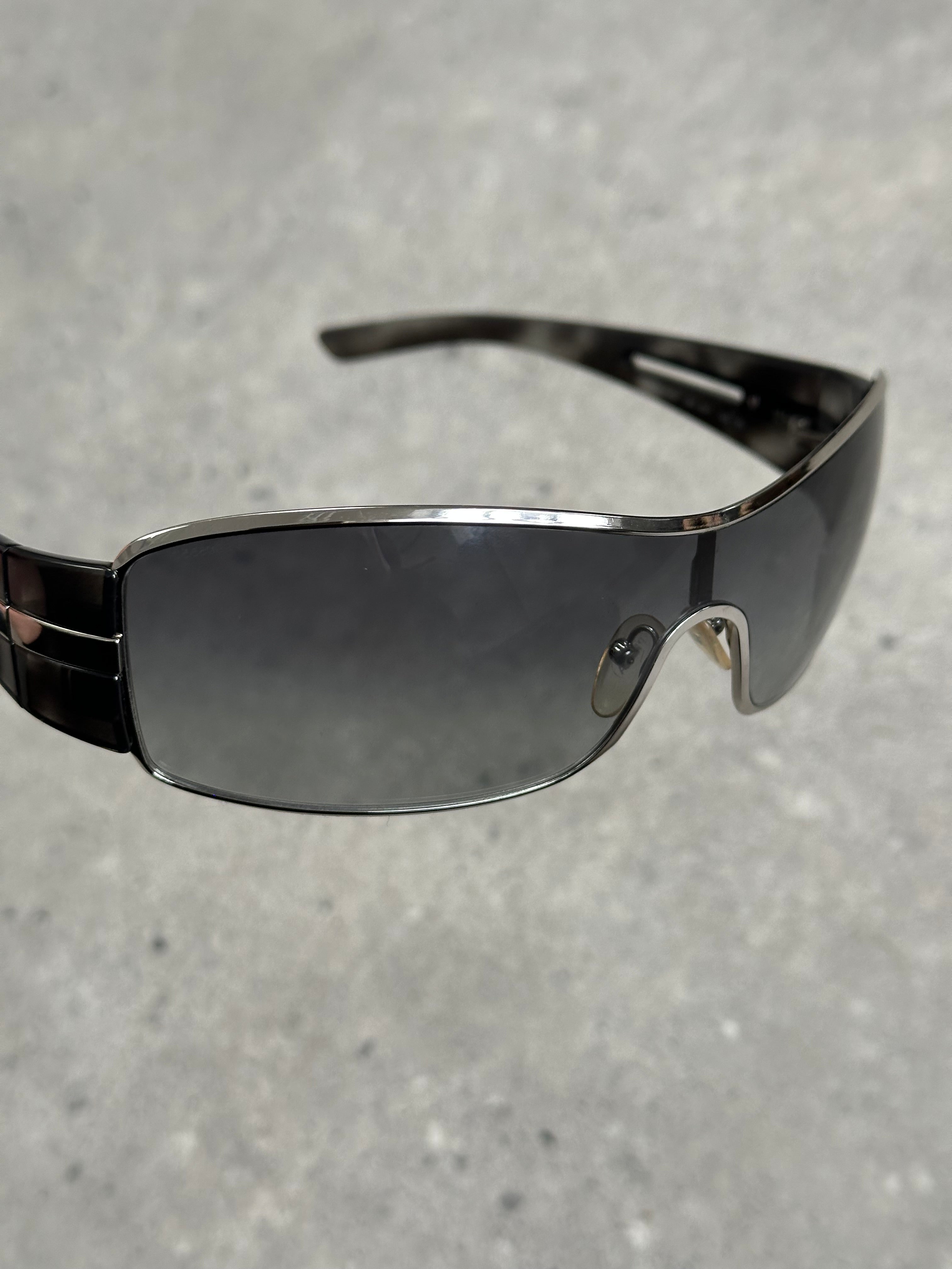 Prada 2000s aviator shield sunglasses with dark tinted lenses and metal frame, stylish and bold eyewear.