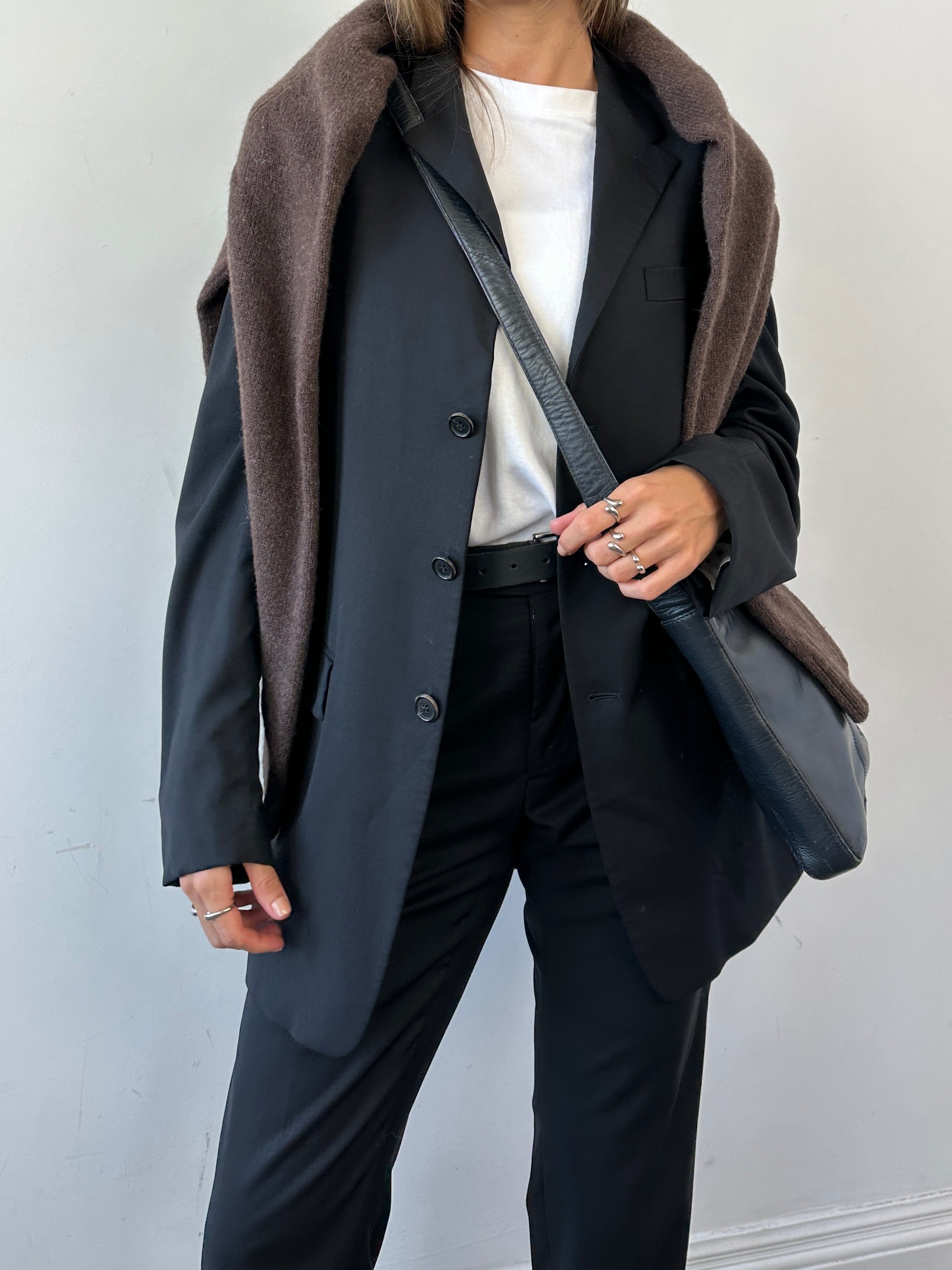Prada virgin wool mid-rise jumpsuit with single-breasted design, tailored fit, and stylish cut in a sleek, professional style.