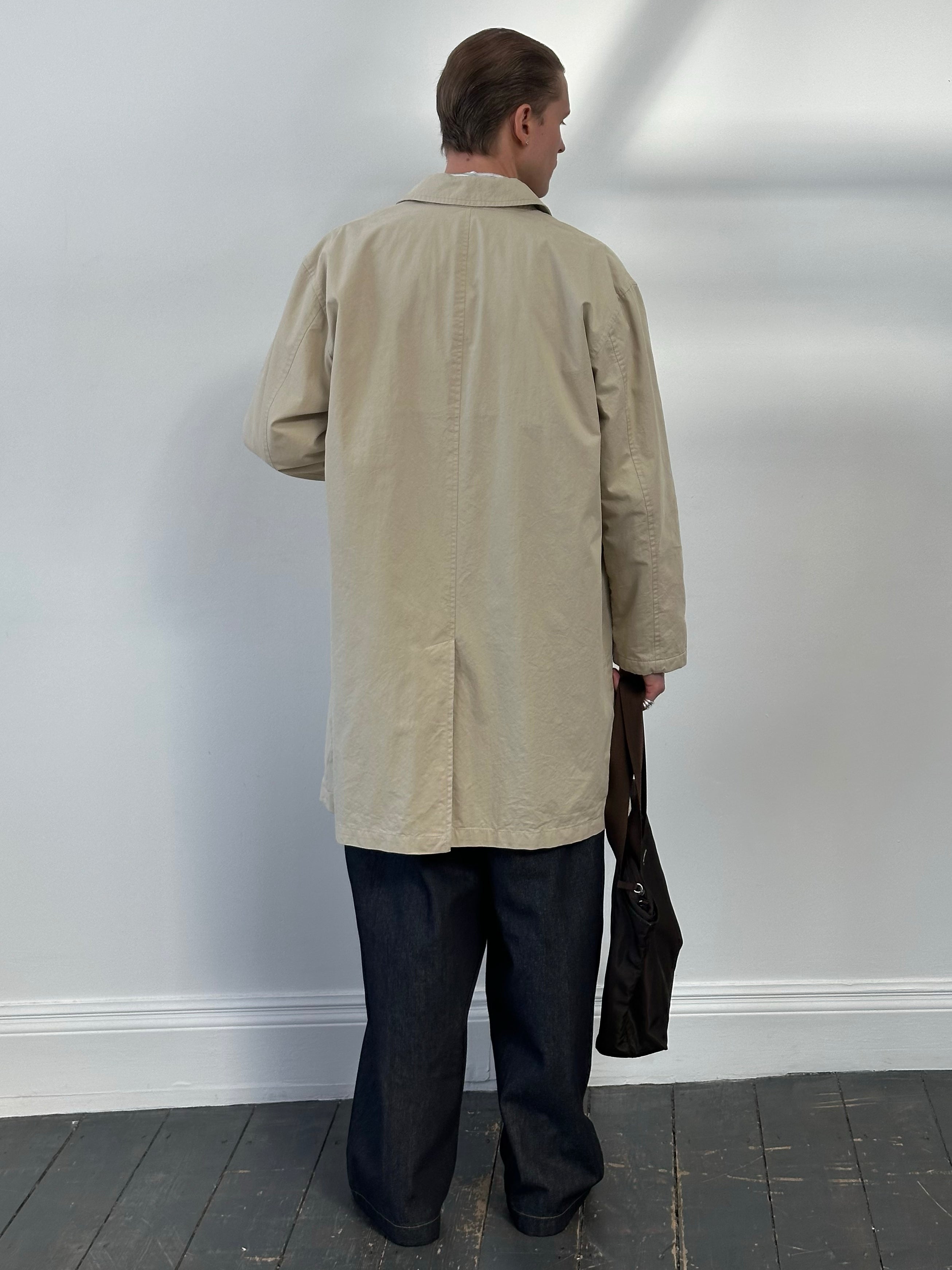 Hugo Boss 2000s cotton trench coat with concealed placket, knee-length, classic beige color, featuring a collar and belt detail.
