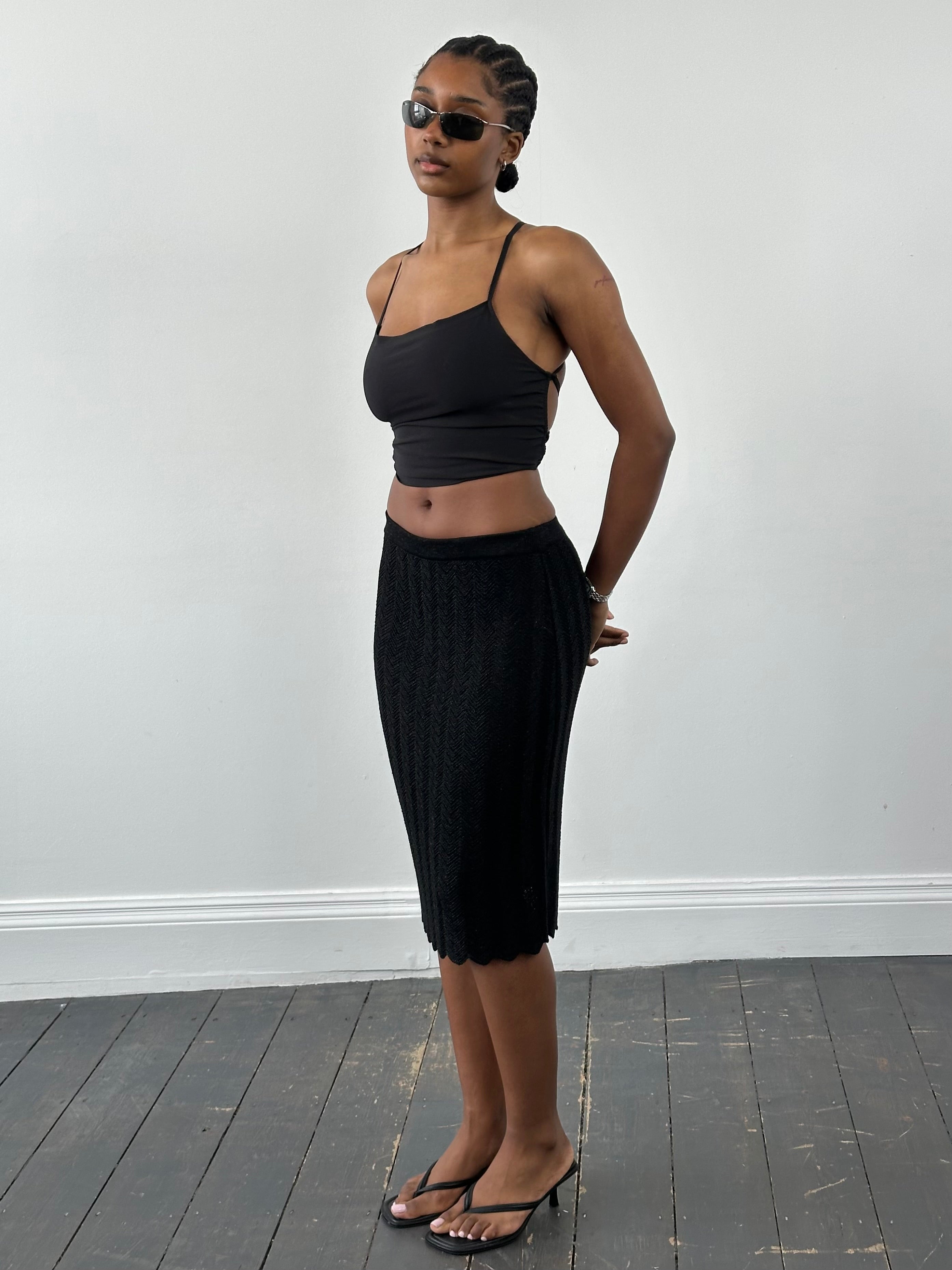 Vintage 1990s knit mini skirt in various sizes, featuring a classic design with a cozy, textured fabric.