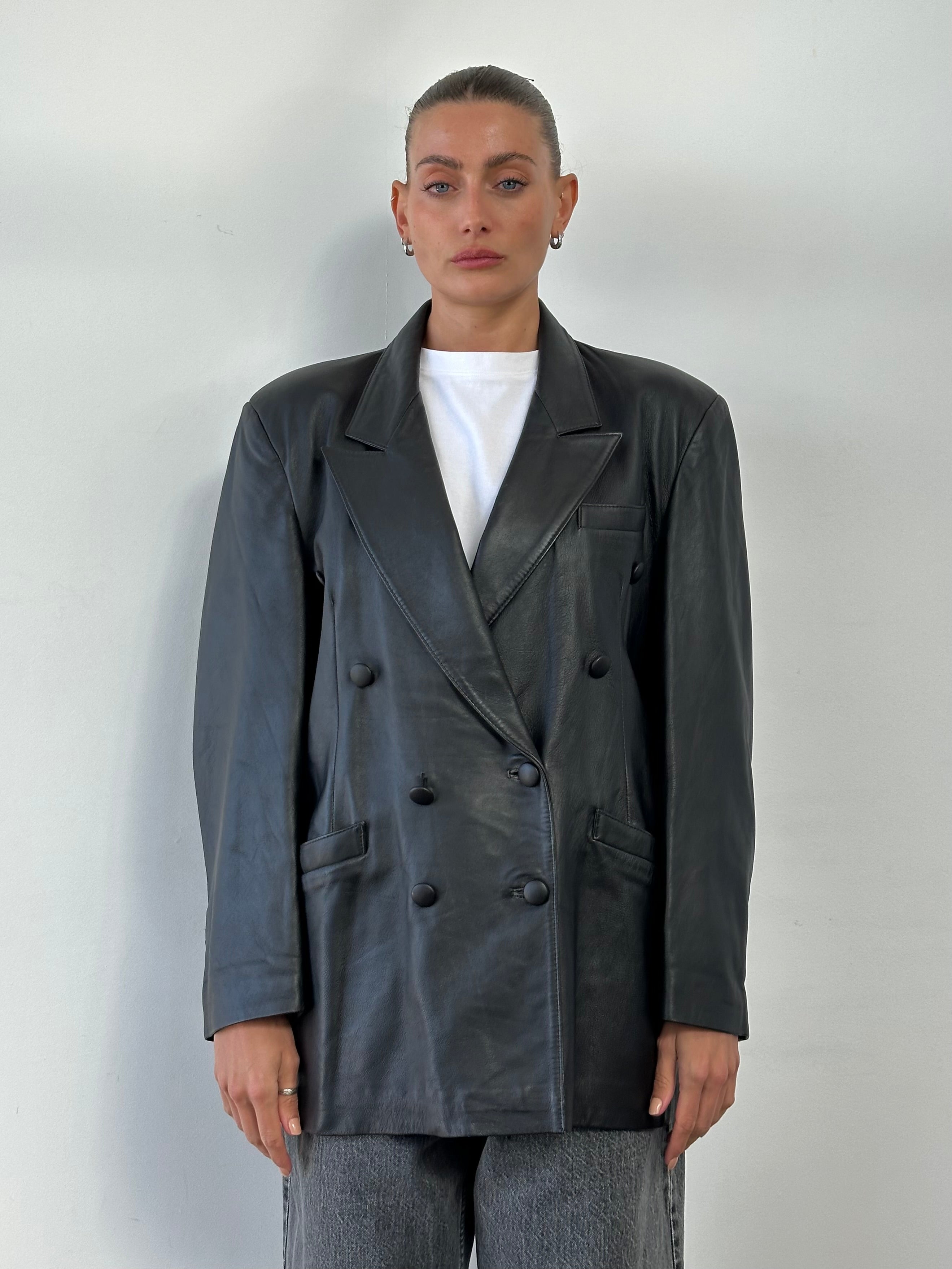 Vintage double-breasted leather blazer jacket, men's size L, stylish and classic, featuring a timeless design with front buttons.
