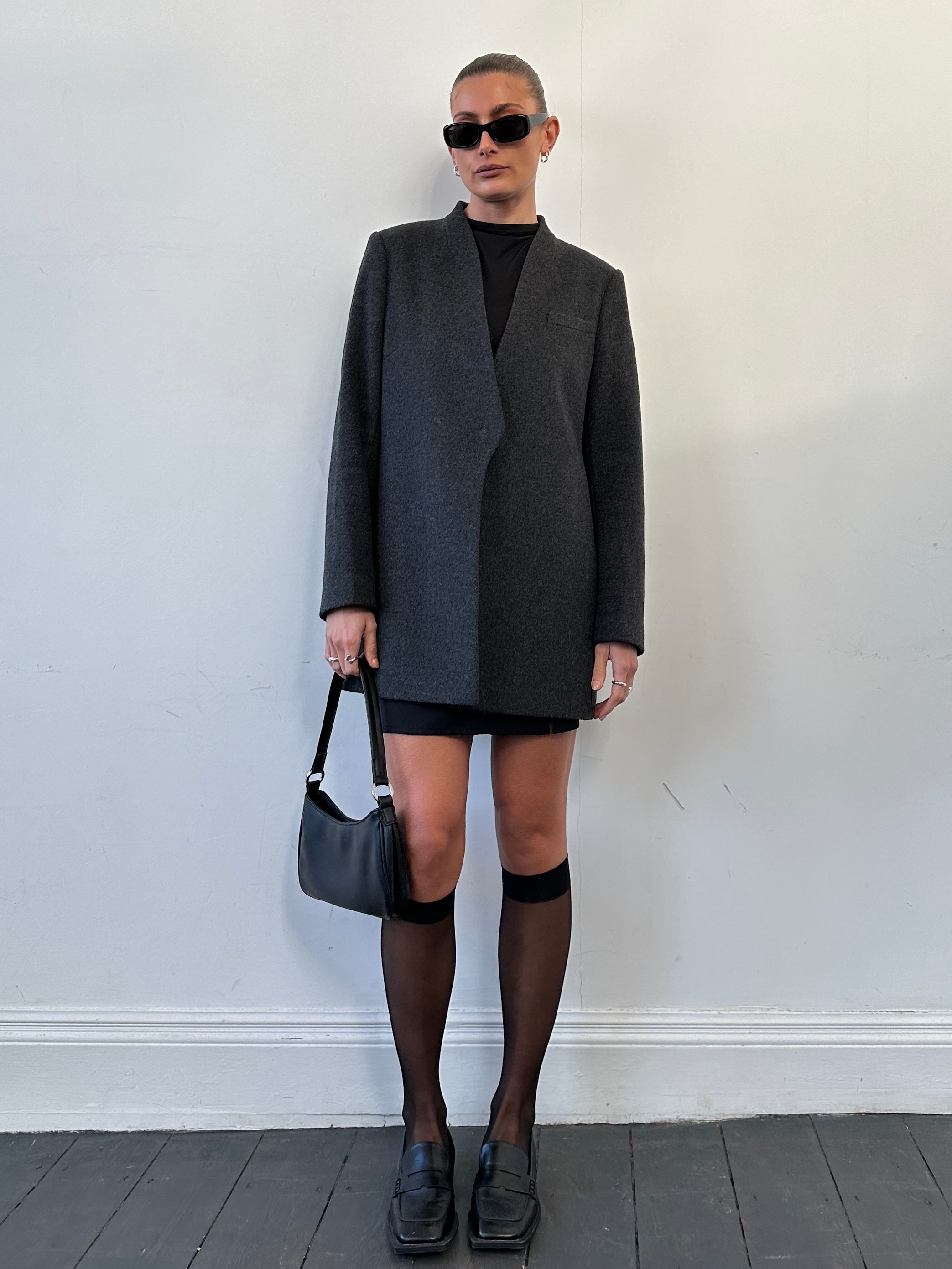 Jaeger minimal wool cashmere coat in size M, shown in a sleek, tailored design with a classic collar and smooth fabric.