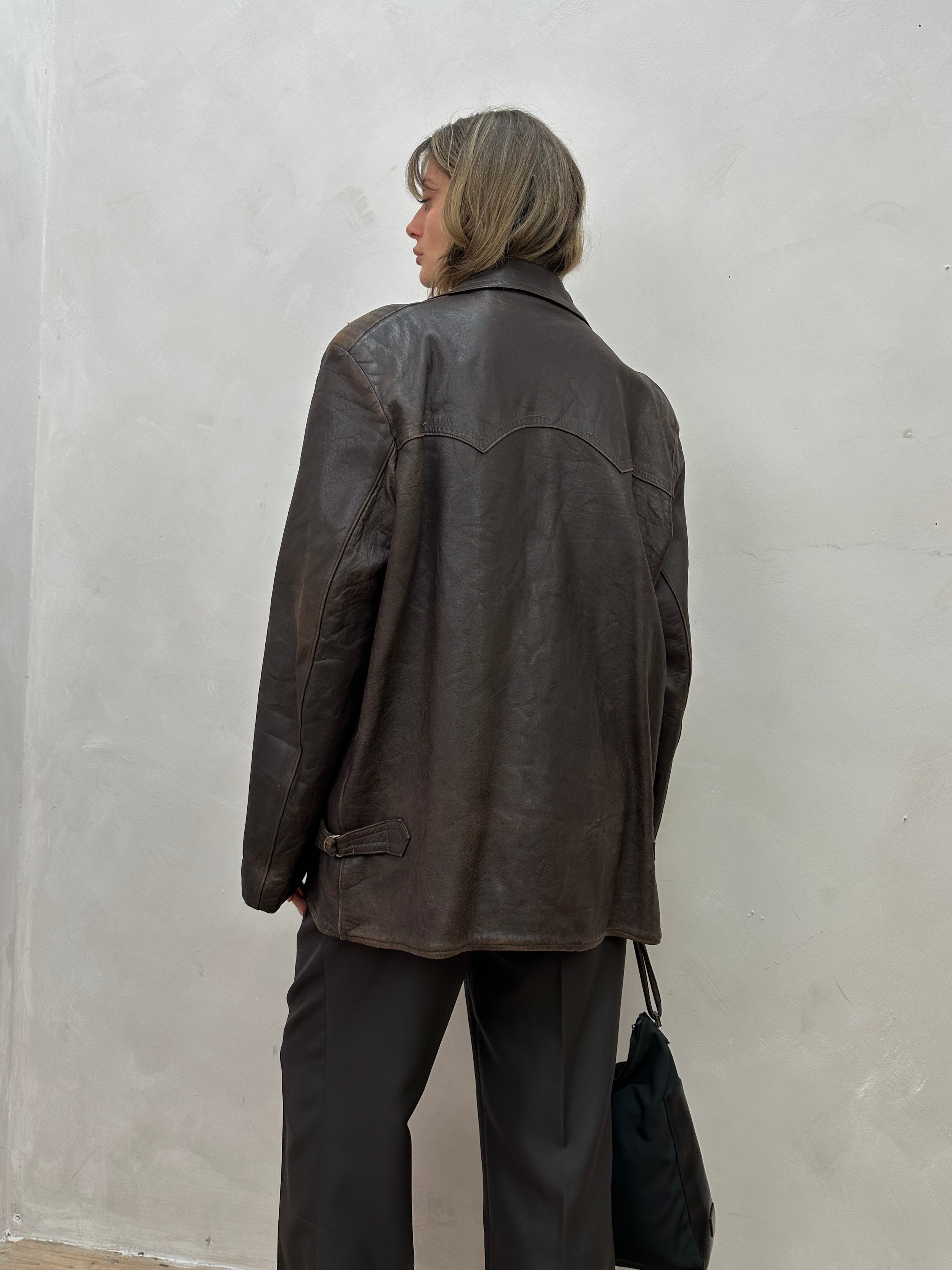 Vintage distressed mid-length leather jacket in XL size, showing rugged texture and classic style with a vintage brand label.