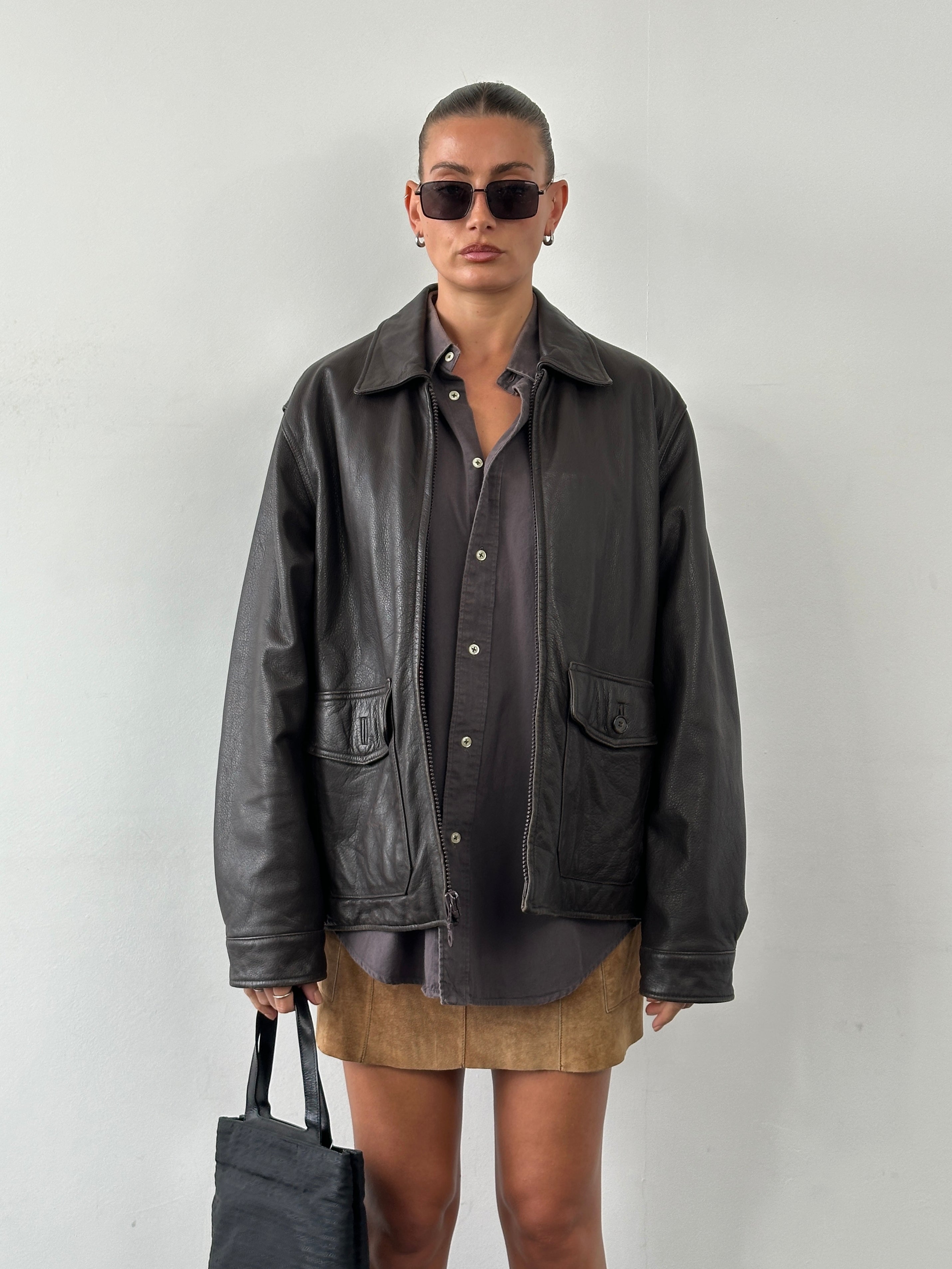 Vintage boxy leather jacket in size L, featuring classic design and durable leather material, displayed on a neutral background.