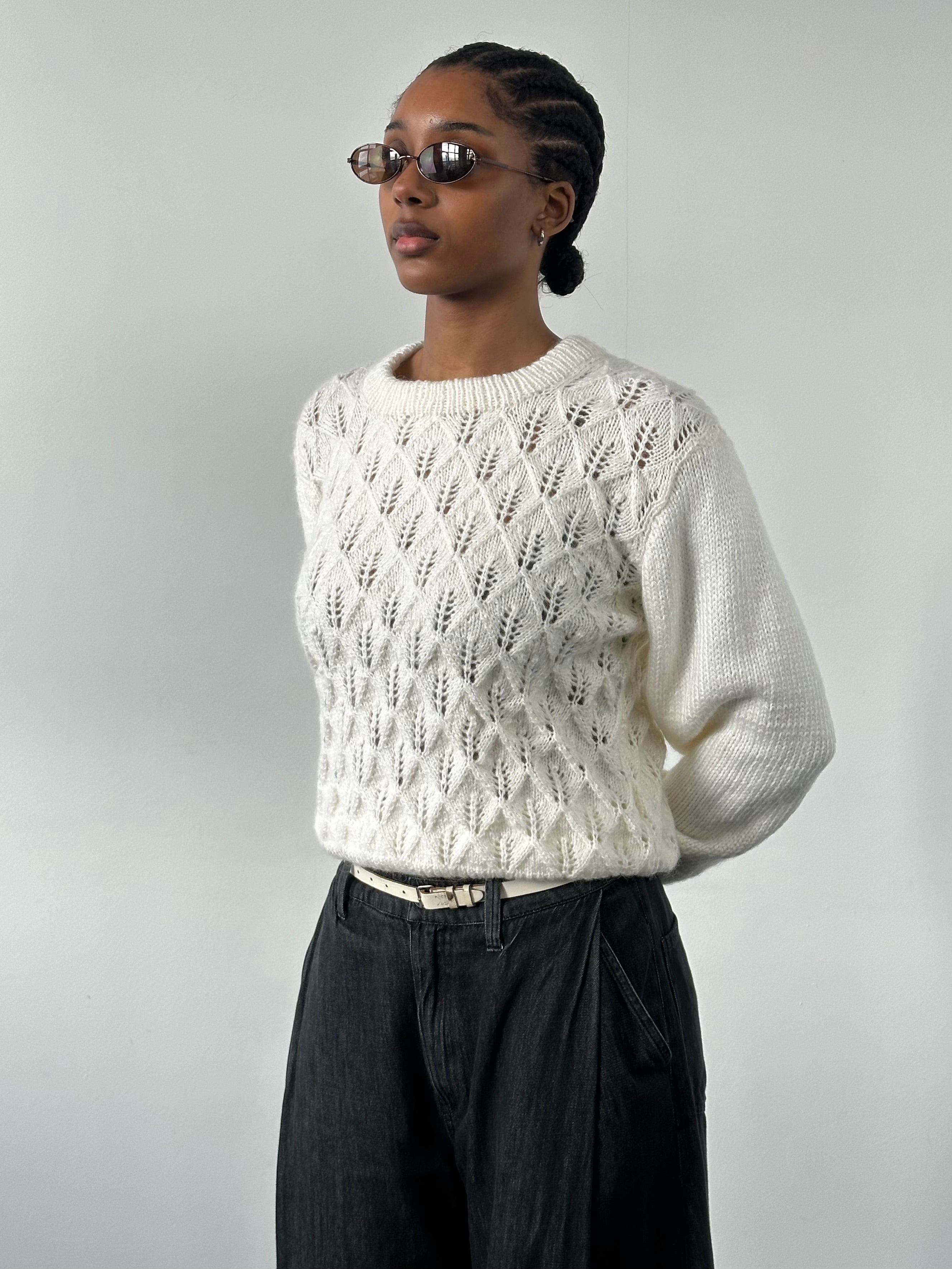 Vintage 1990s wool knit jumper in S/M, featuring classic patterns and cozy texture, perfect for retro winter style.